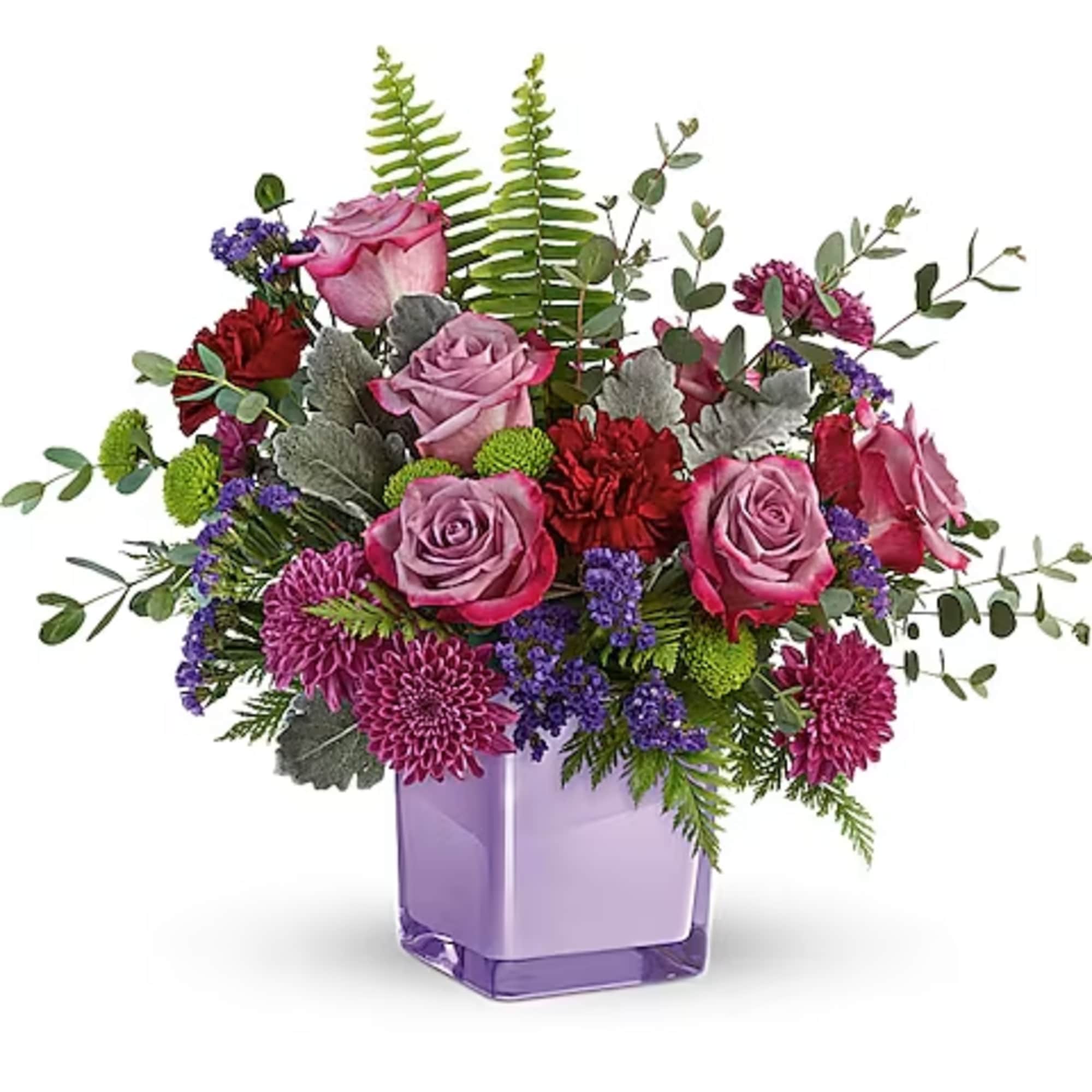 Mixed bouquet of pink roses and purple flowers in a lavender vase