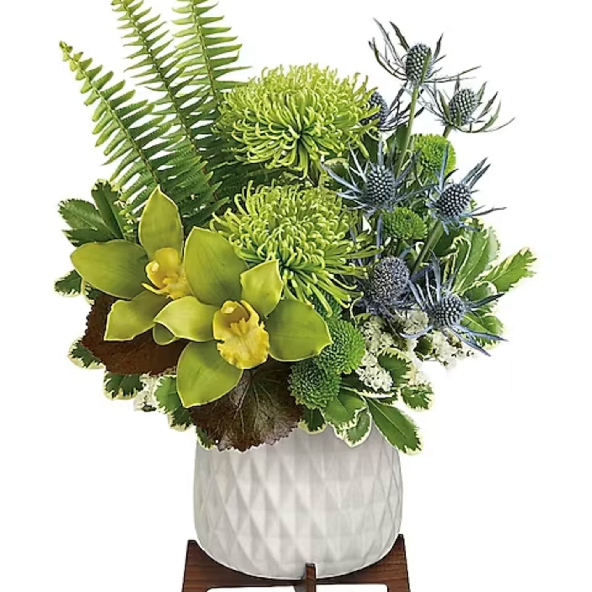 Green floral arrangement in a white textured vase