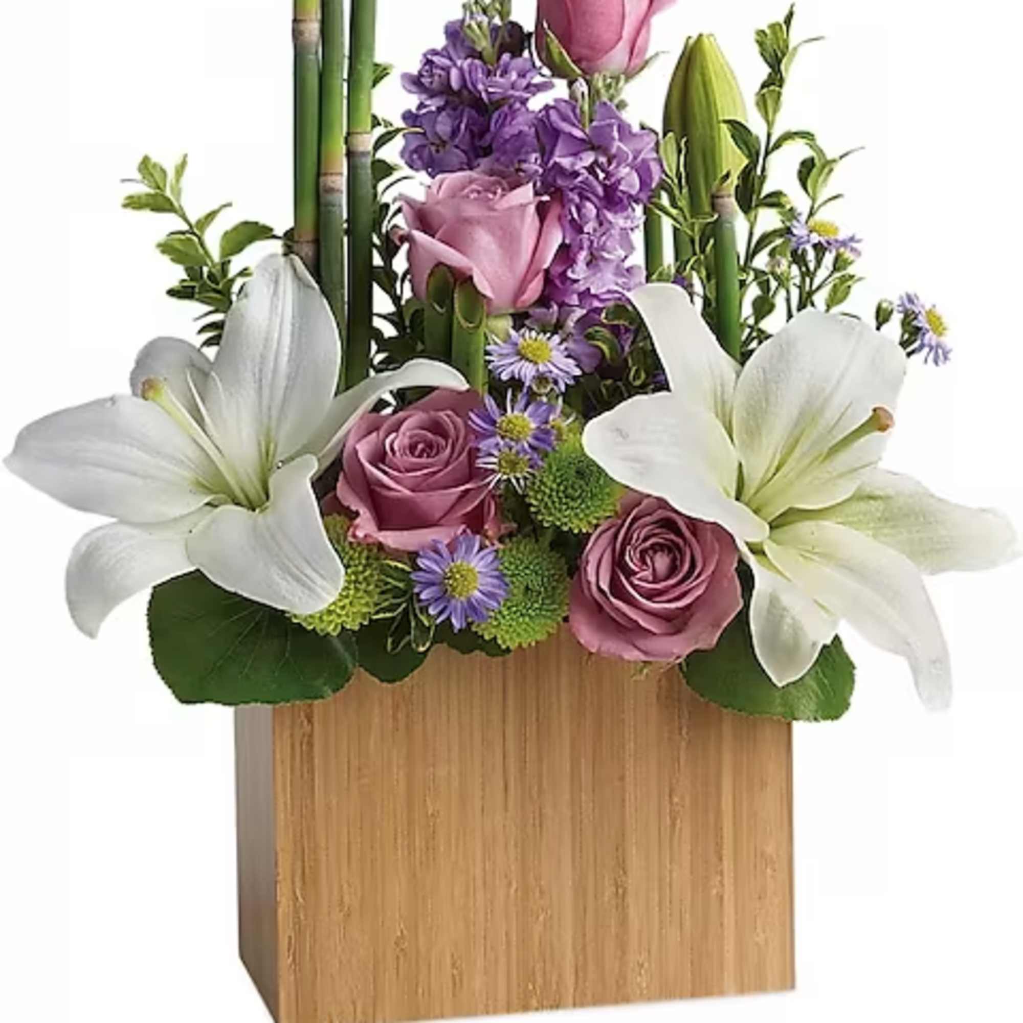 Pink roses and white lilies arranged in a wooden box