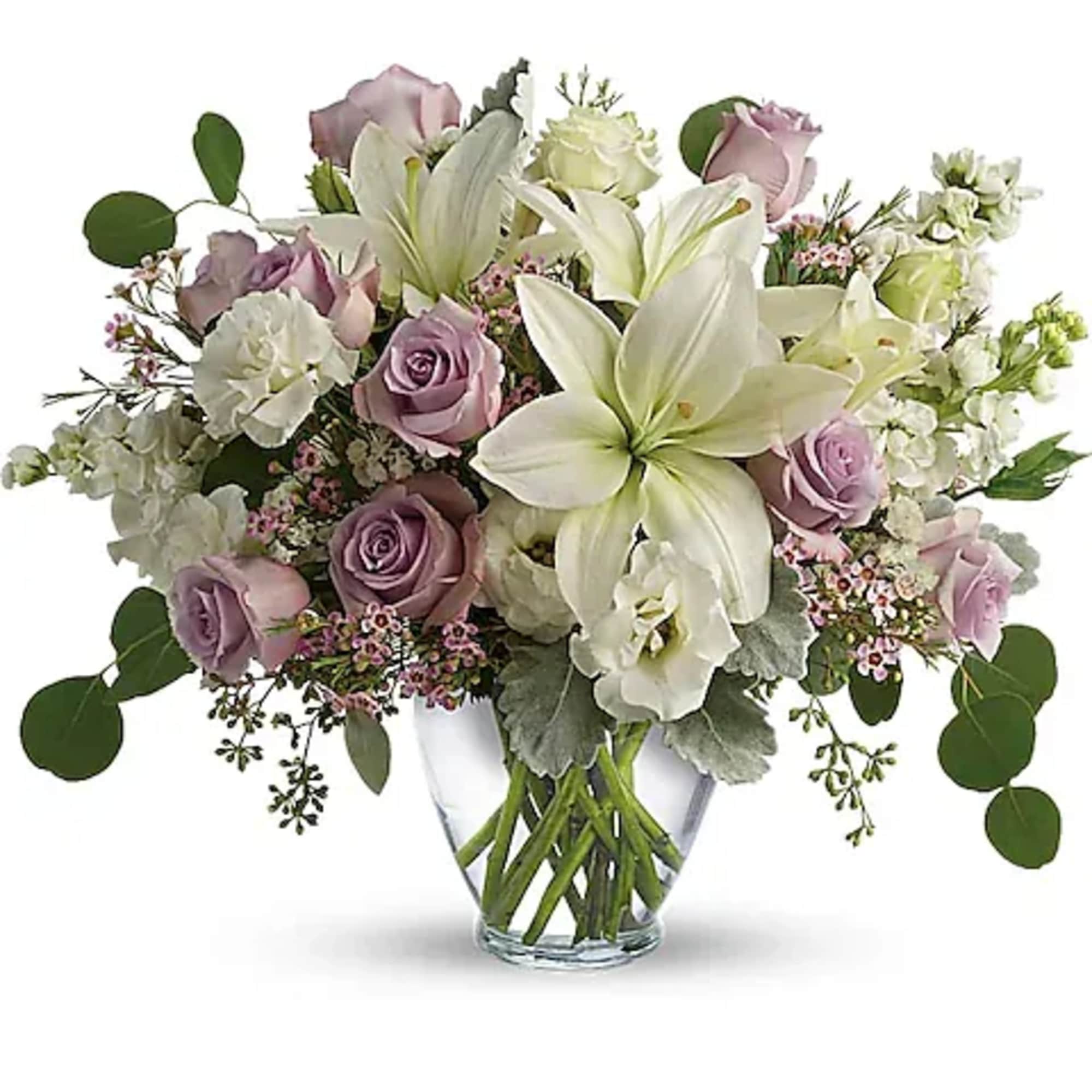 Bouquet of white lilies and lavender roses in a clear glass vase