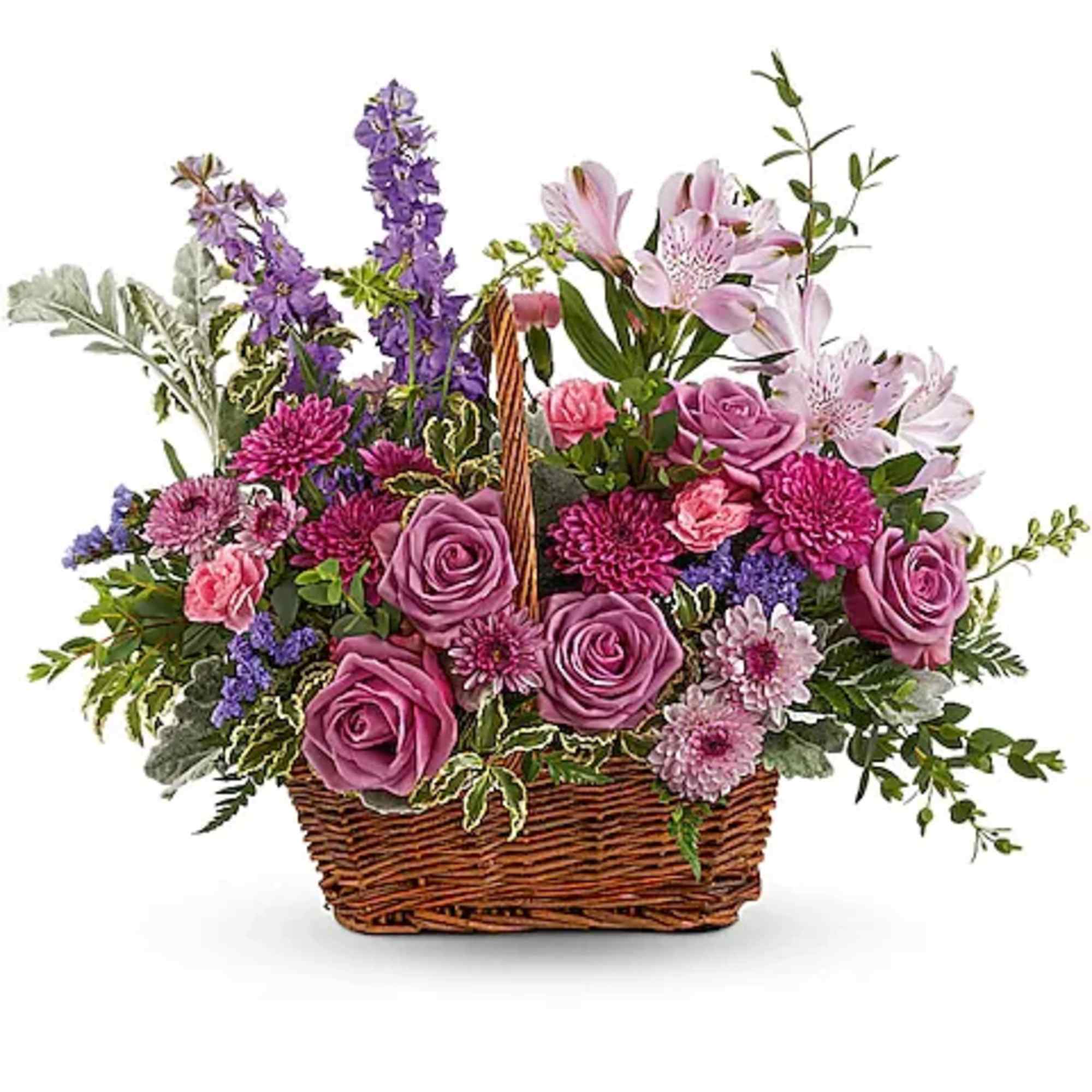 Basket arrangement of pink and purple flowers