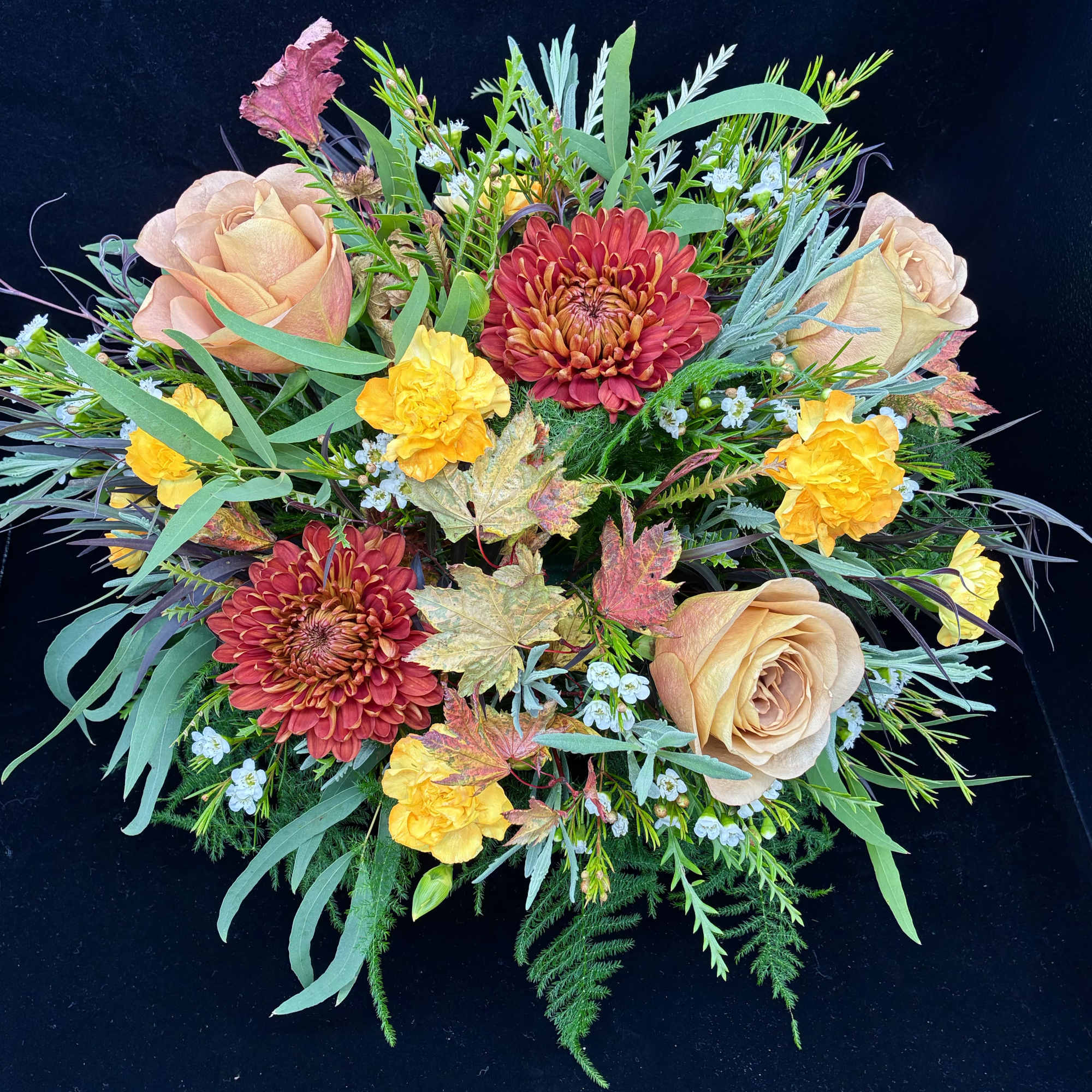 Autumn bouquet with peach roses, red mums, and yellow carnations