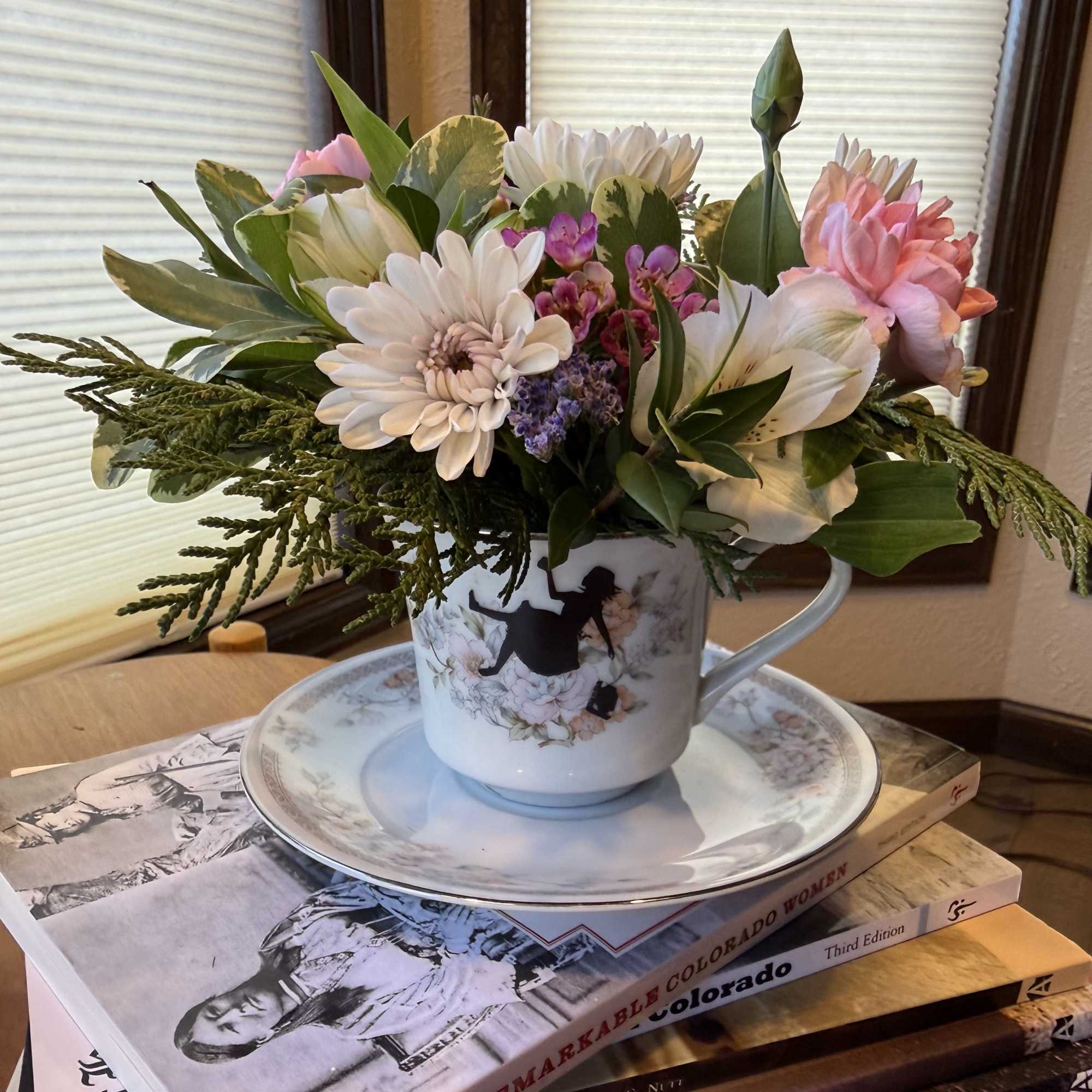 Mixed bouquet in a floral teacup on a saucer