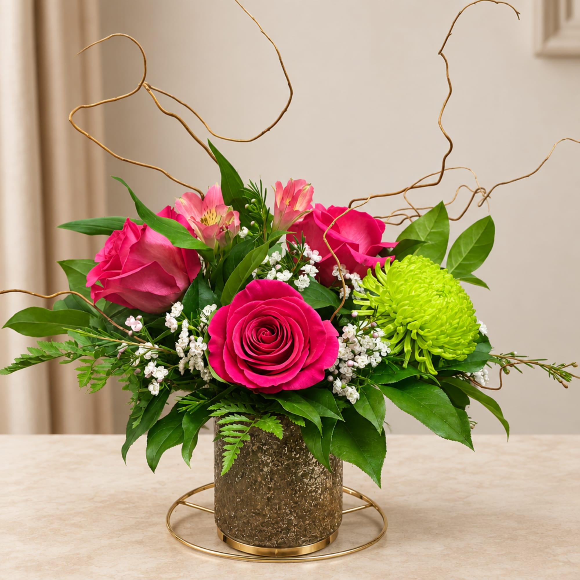 Pink roses and green chrysanthemum in a gold vase with curly branches