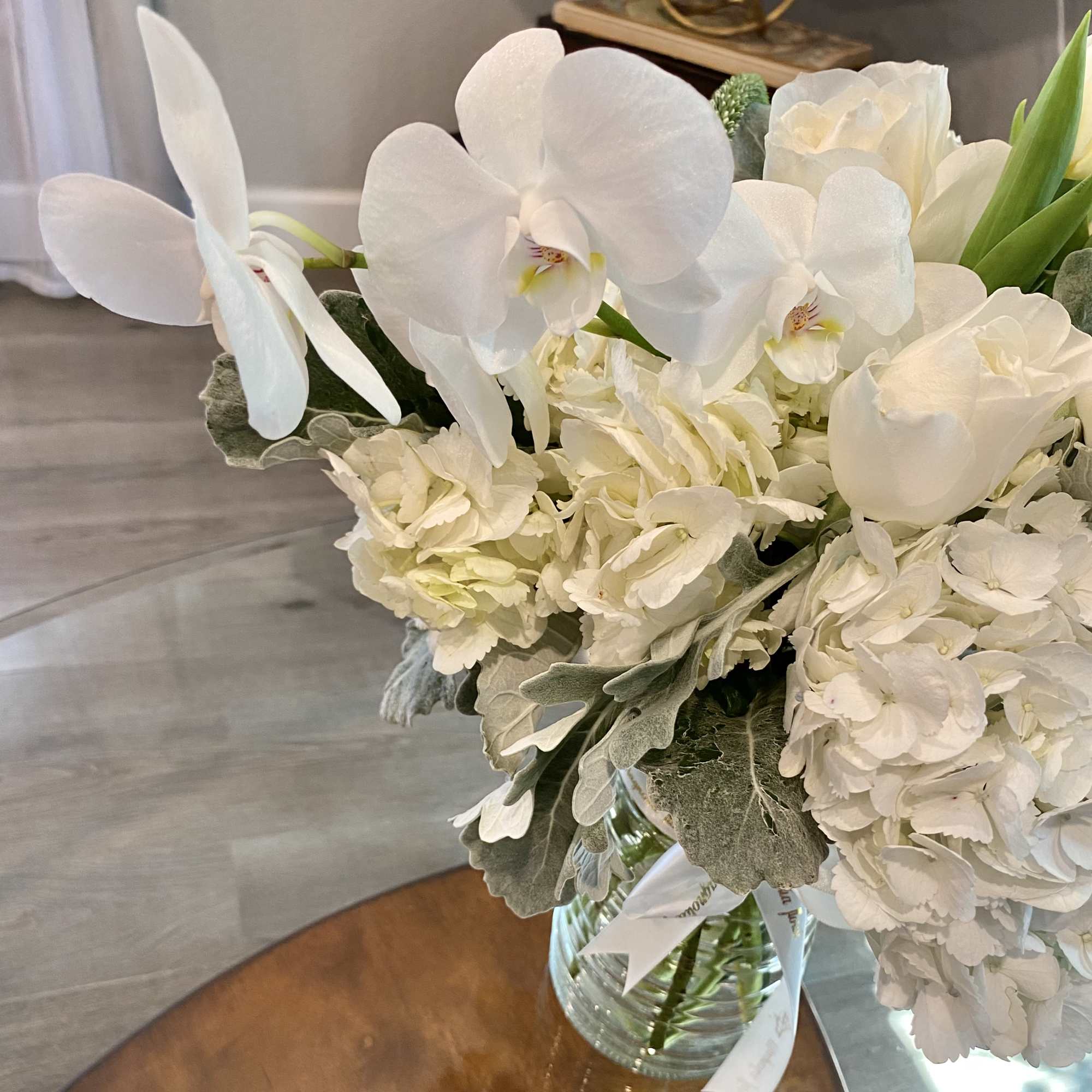 White orchids and hydrangeas in a glass vase