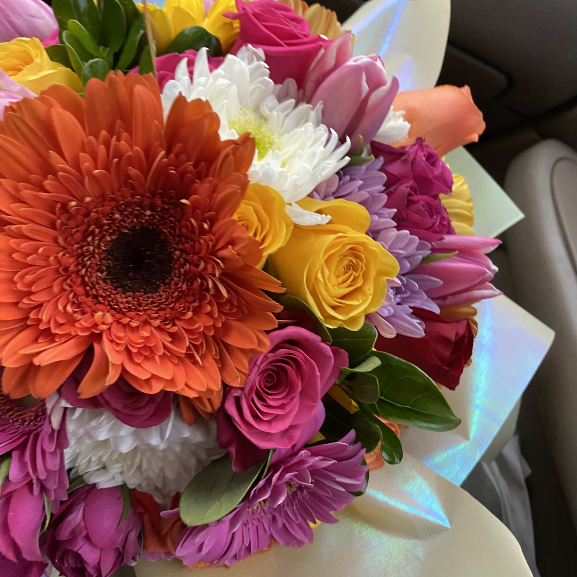Bright mixed bouquet with gerbera daisies, roses, and tulips