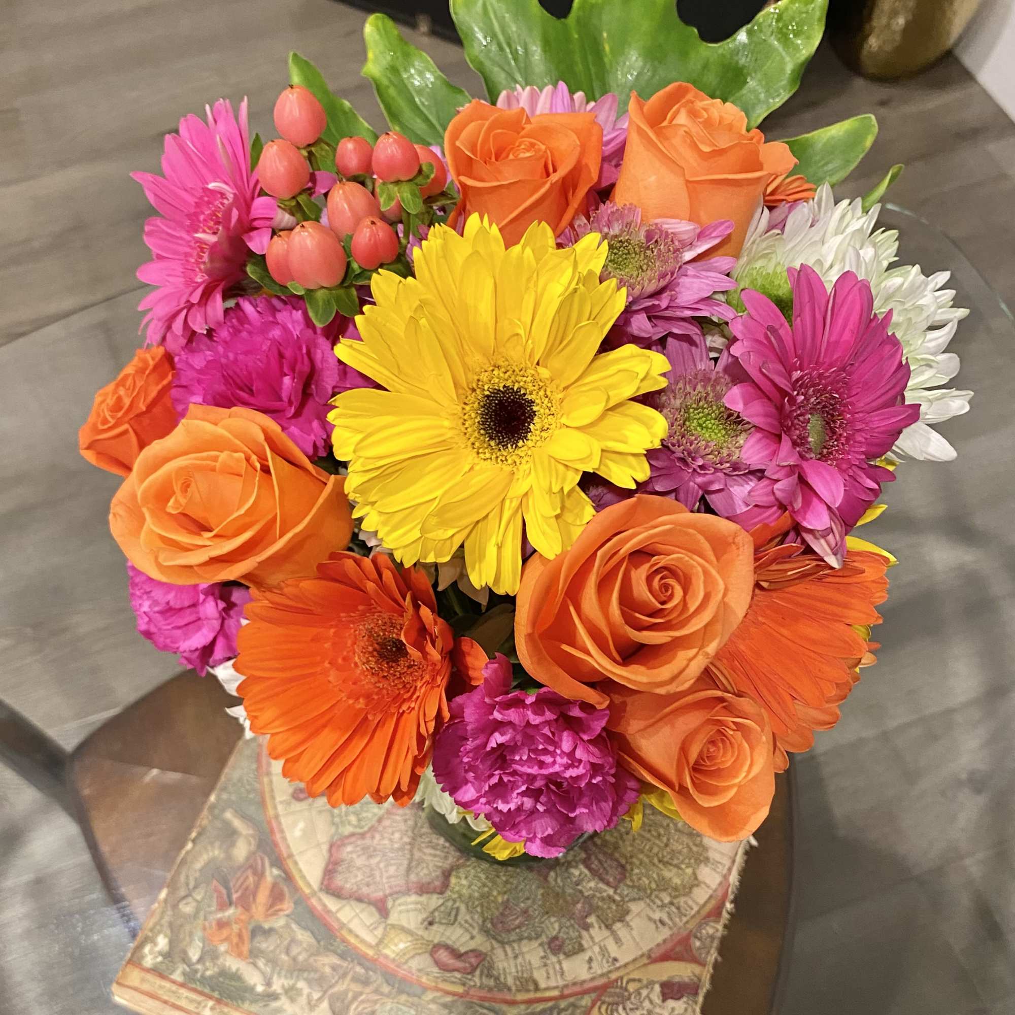 Bright mixed bouquet with orange roses, gerbera daisies, and pink flowers
