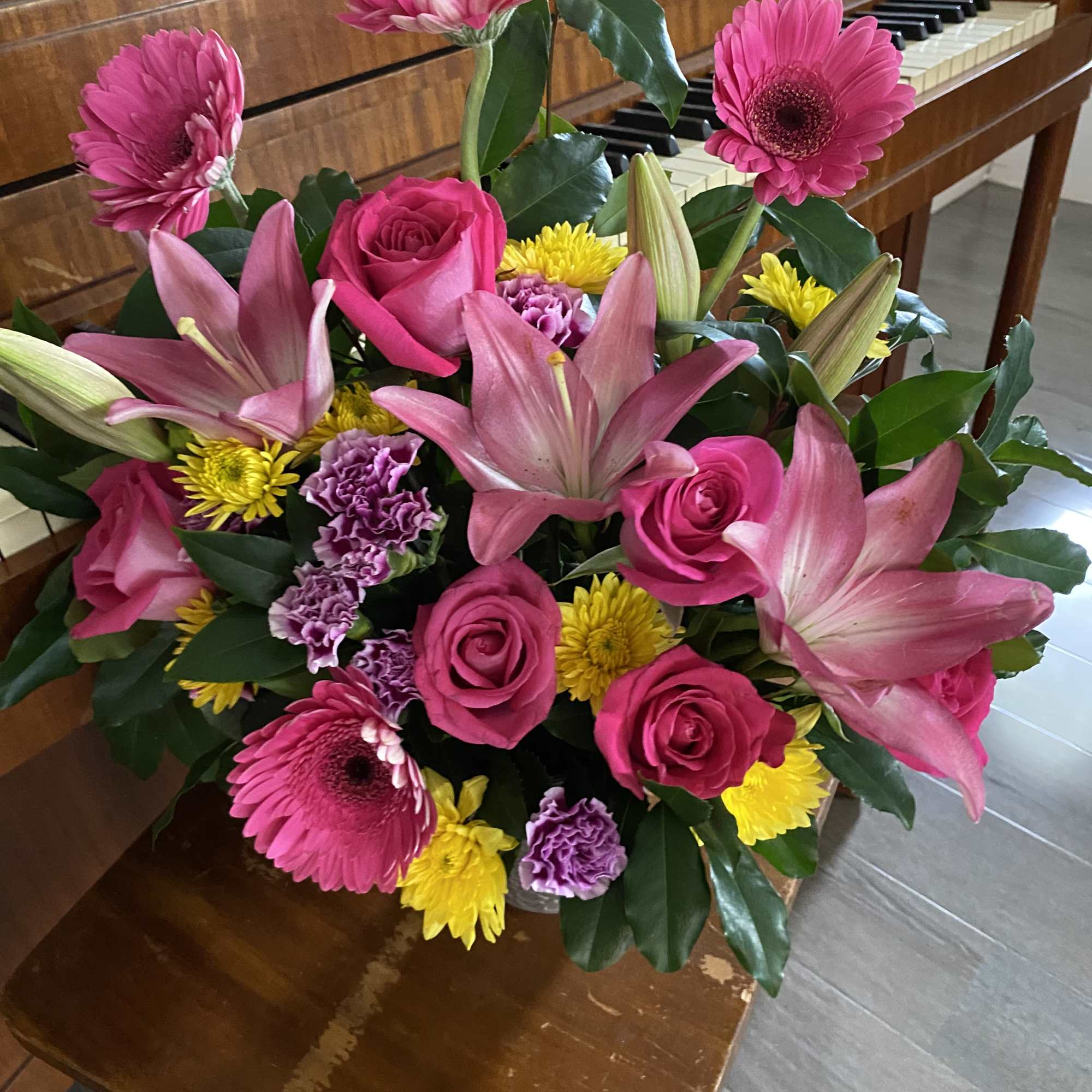 Bouquet of pink lilies, roses, gerbera daisies, and yellow mums