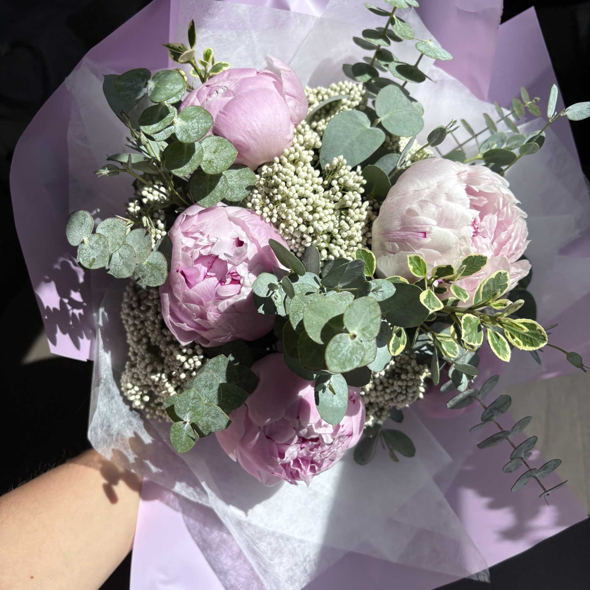 Pink peonies with eucalyptus in lavender wrapping paper