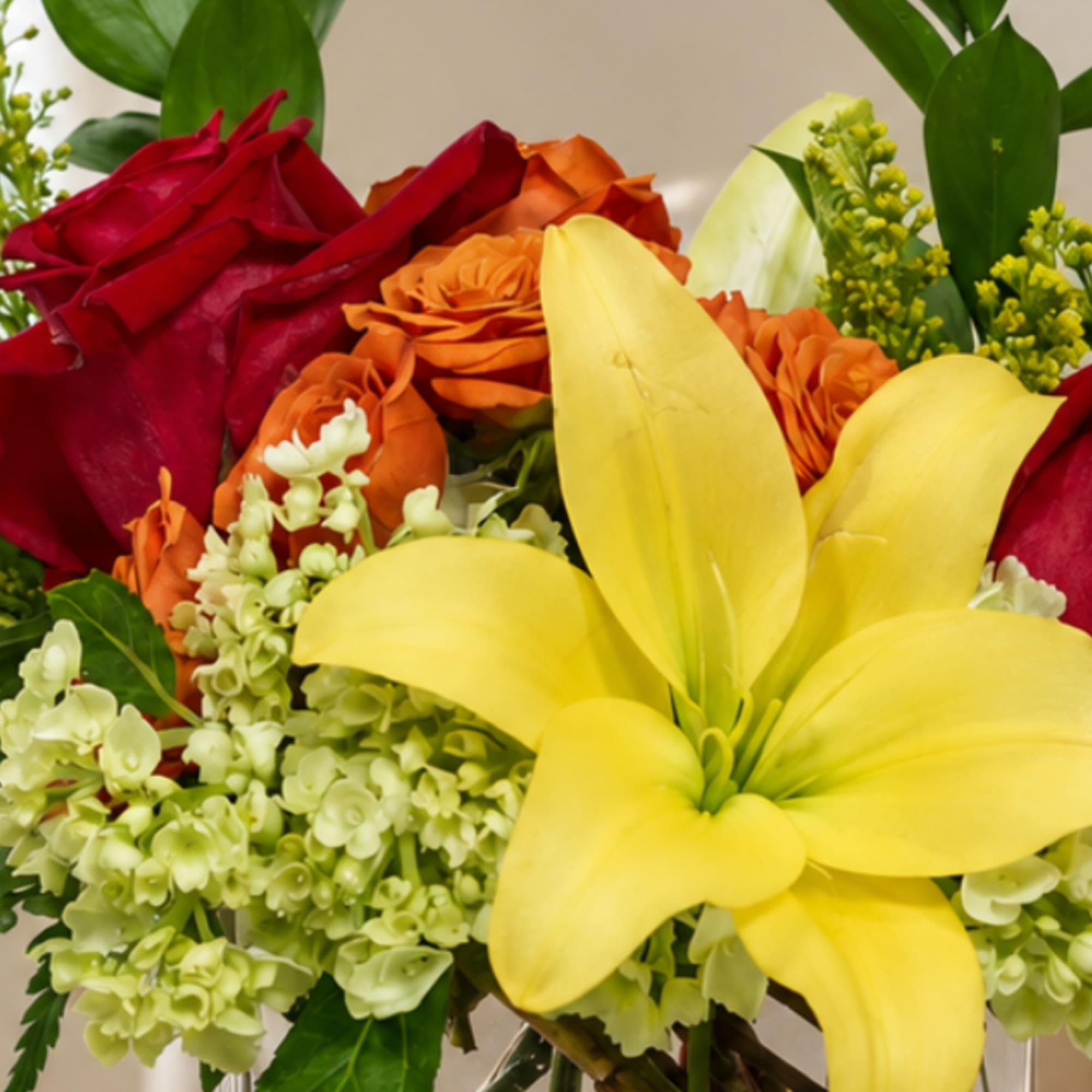 Bouquet of red and orange roses with yellow lilies