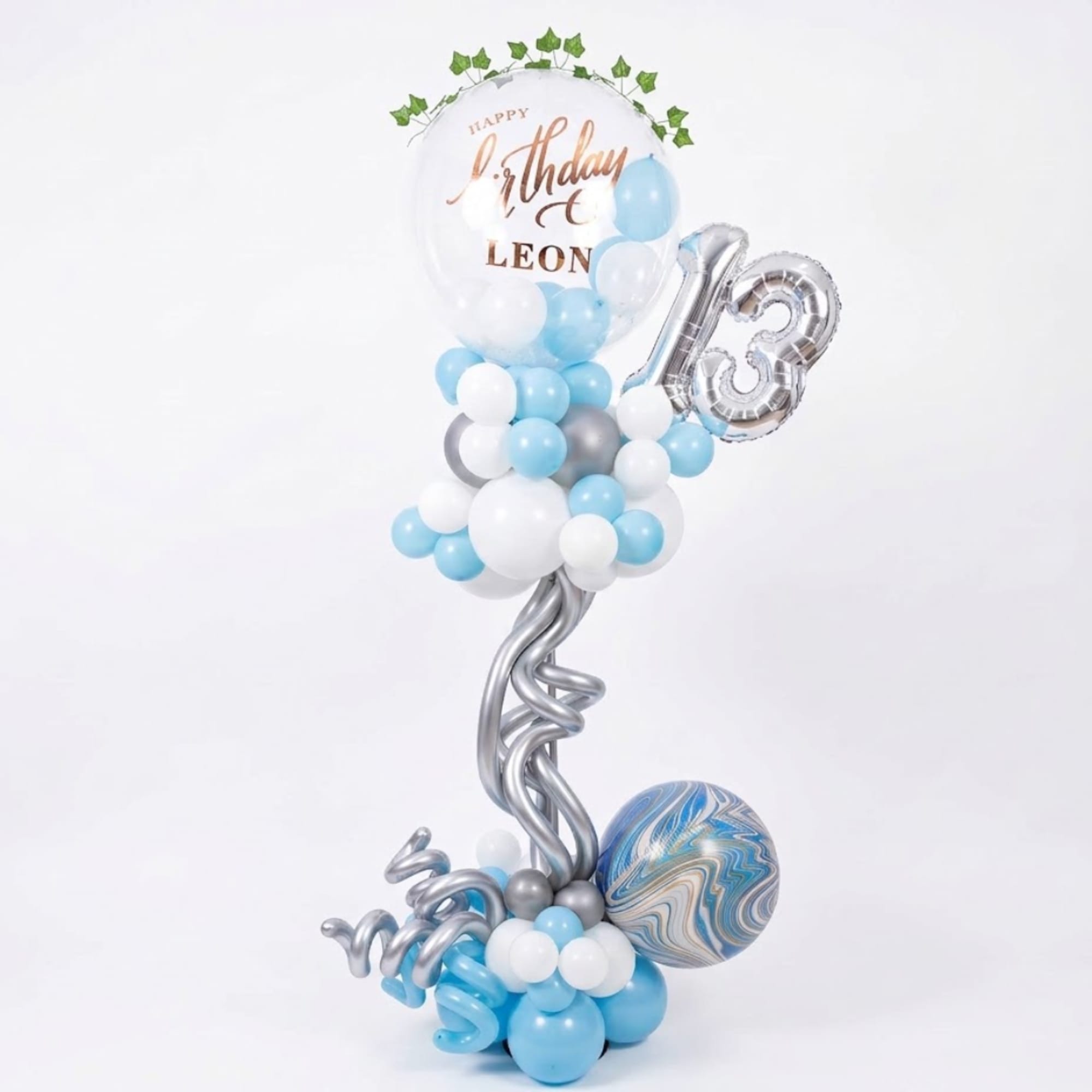 Birthday balloon arrangement with a silver 13 and blue-white balloons