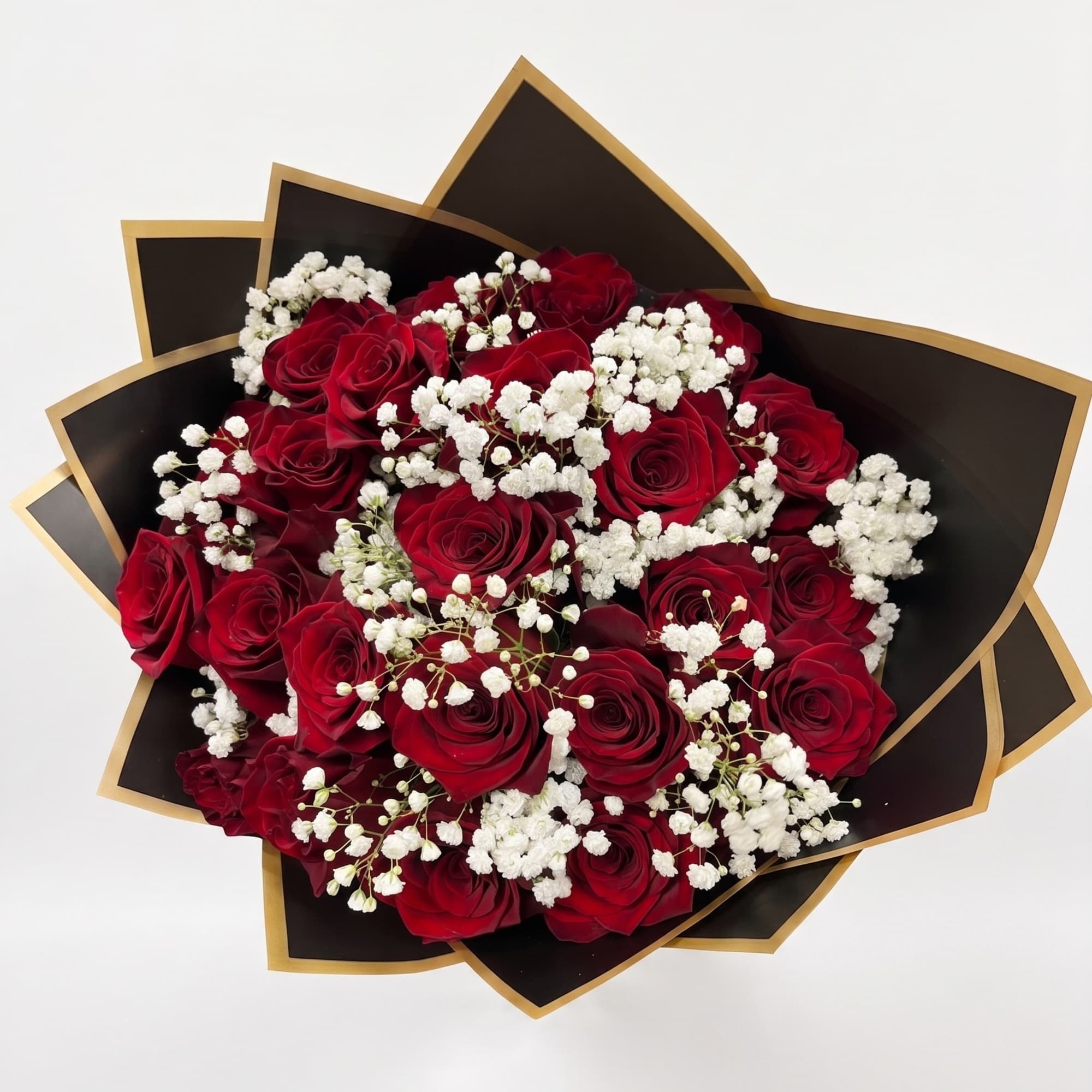 Bouquet of red roses with white baby's breath in black and gold wrap