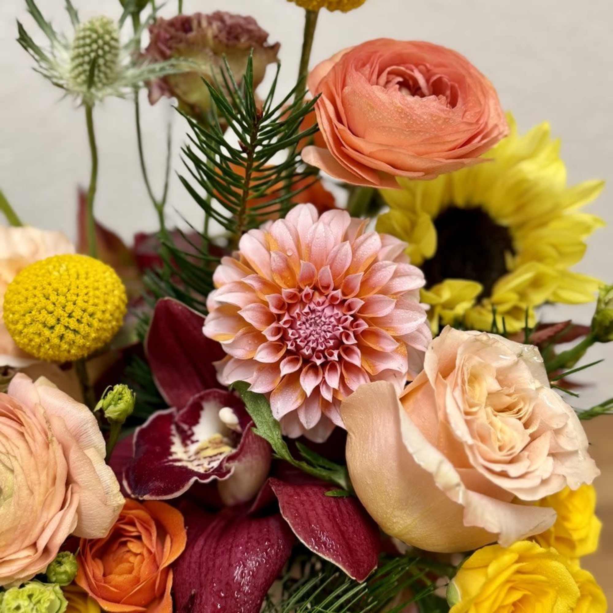 Mixed bouquet with peach, yellow, and burgundy flowers