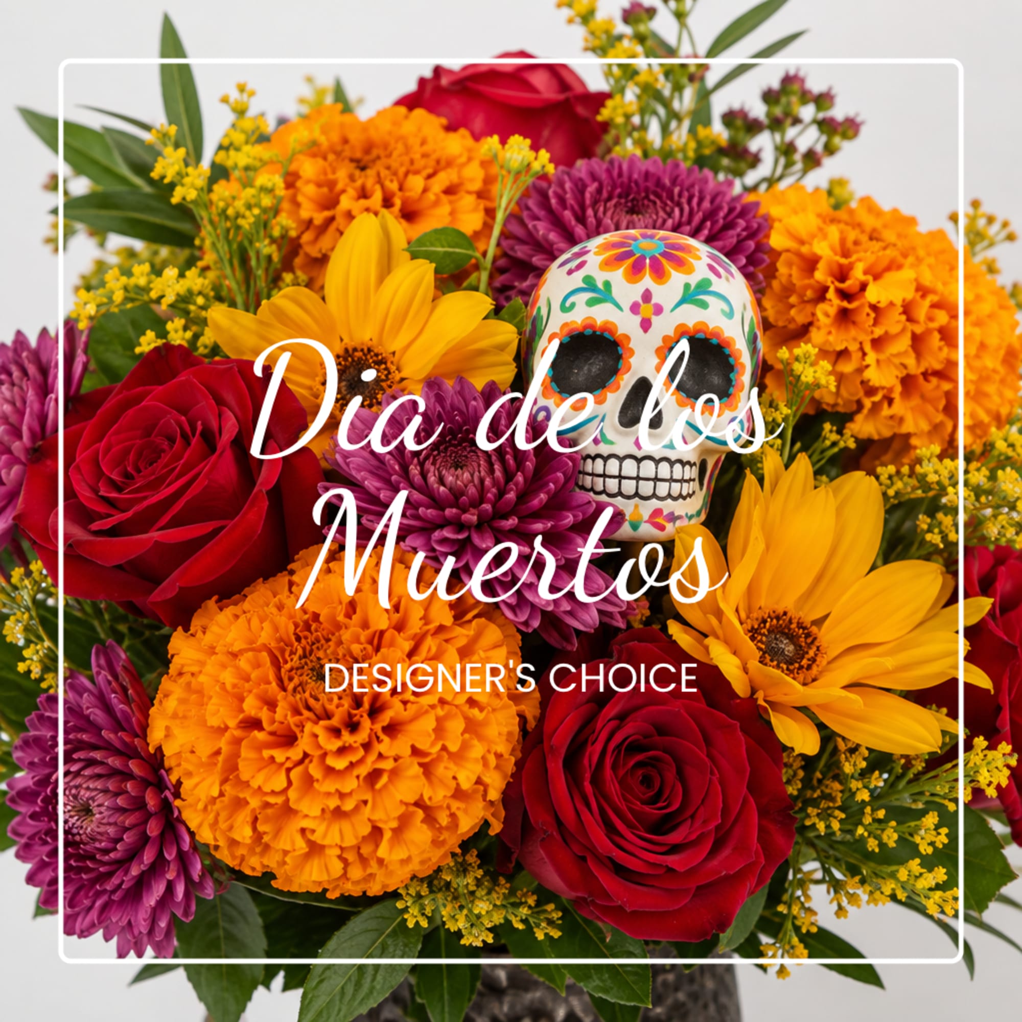 Colorful flower arrangement with roses, marigolds, and a sugar skull decoration