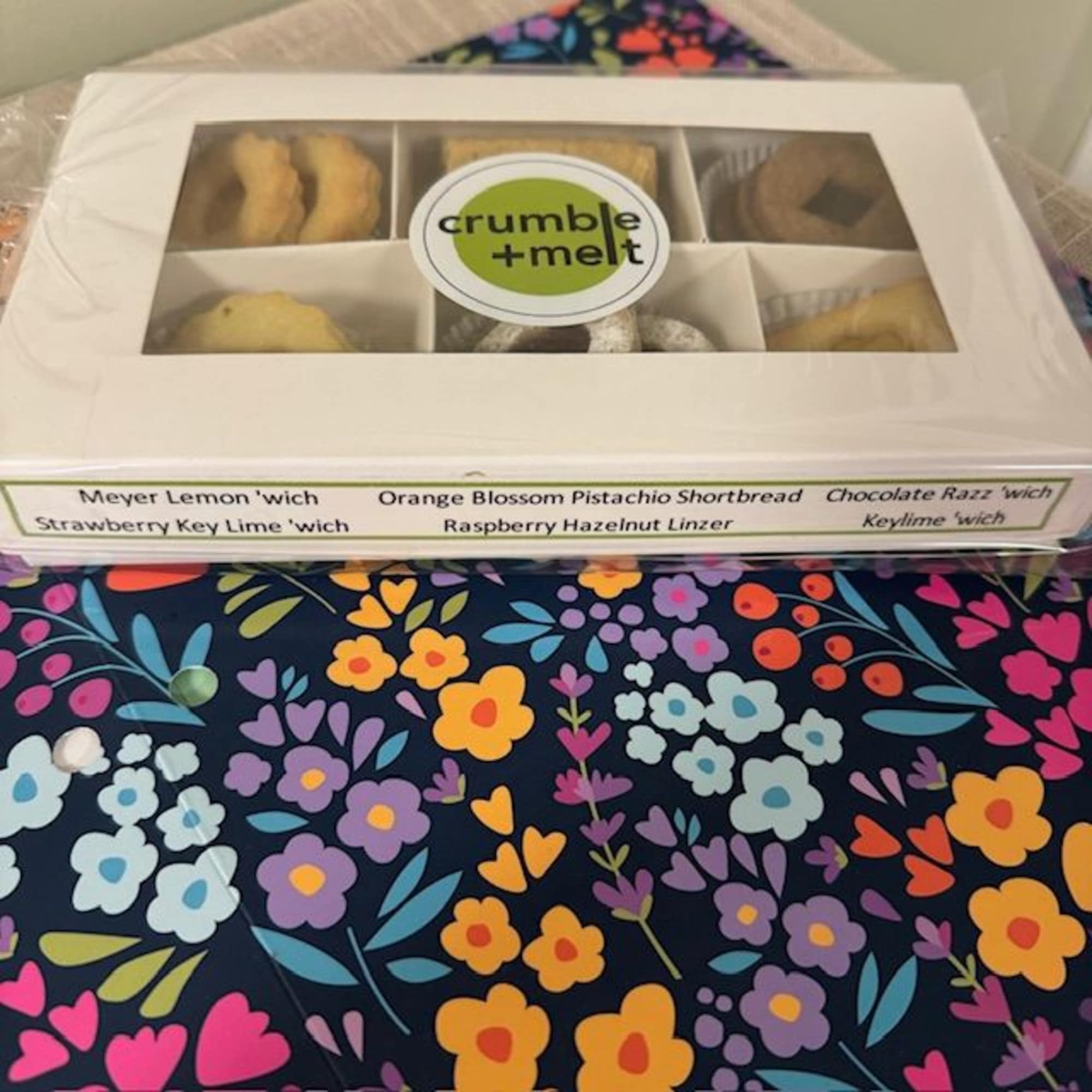 Box of assorted cookies with a clear lid and label