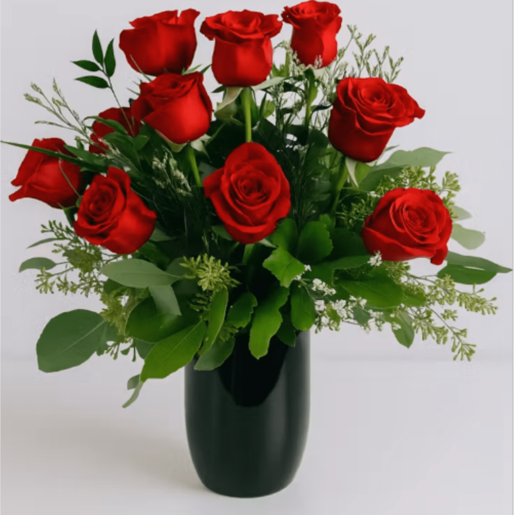 Velvety red roses arranged in a compact, rounded bouquet make an immediate
