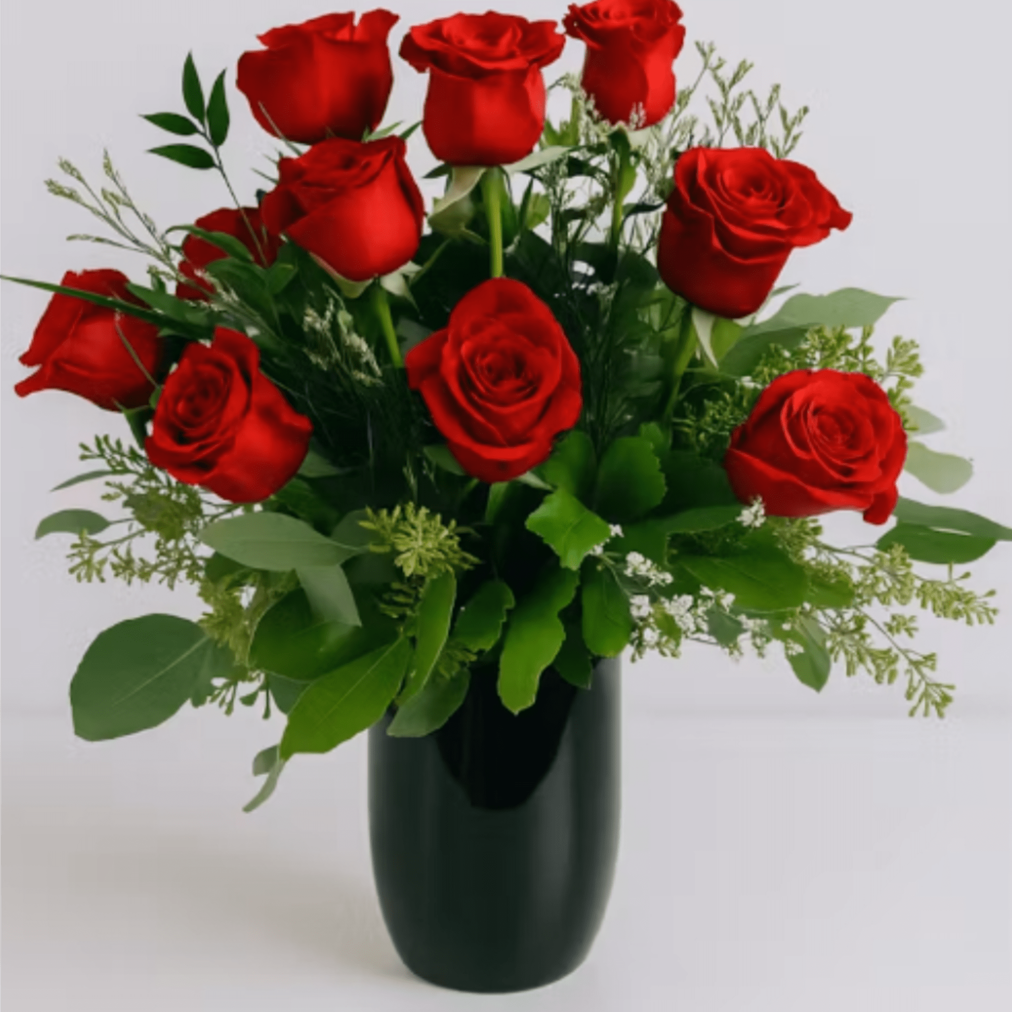 Velvety red roses arranged in a compact, rounded bouquet make an immediate