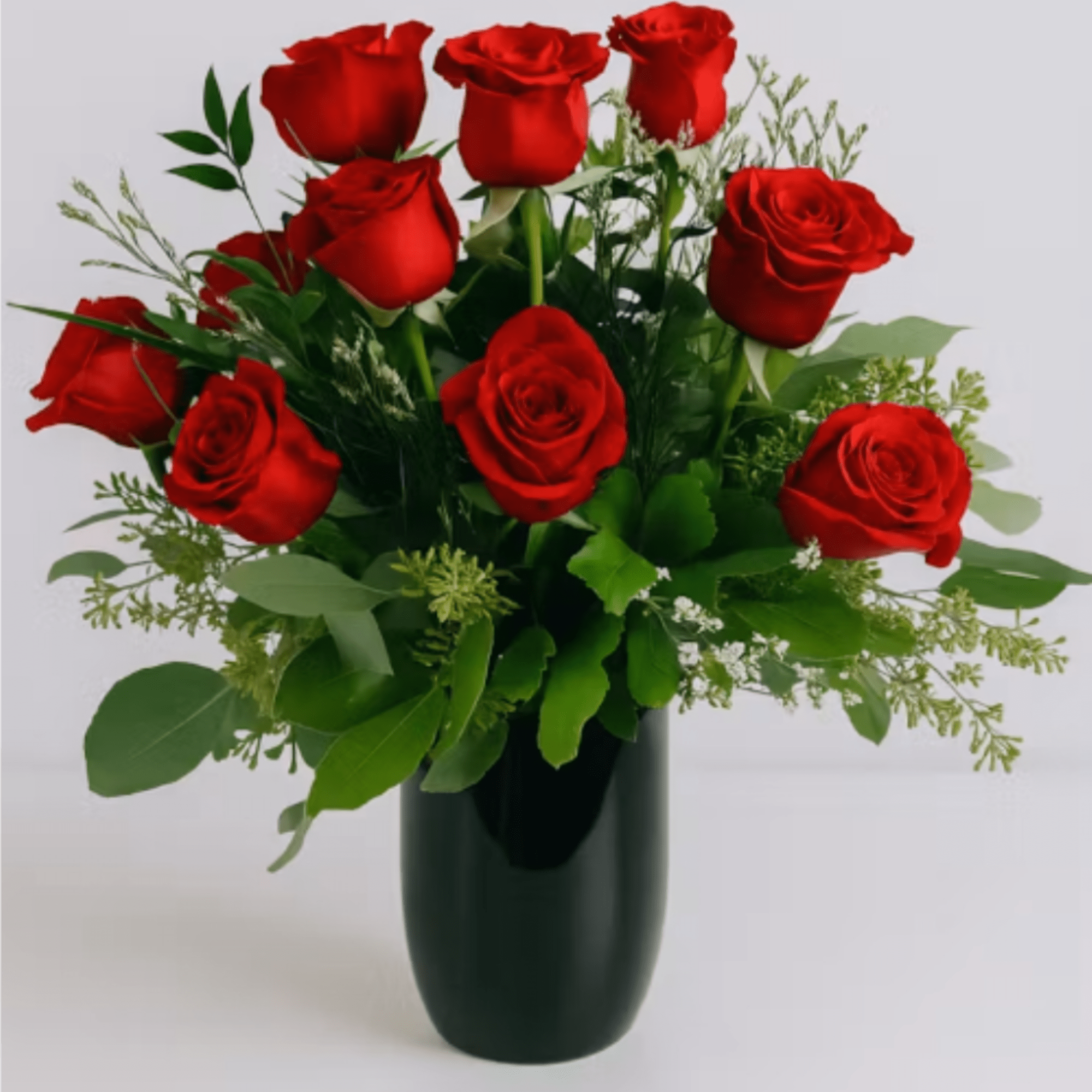 Velvety red roses arranged in a compact, rounded bouquet make an immediate