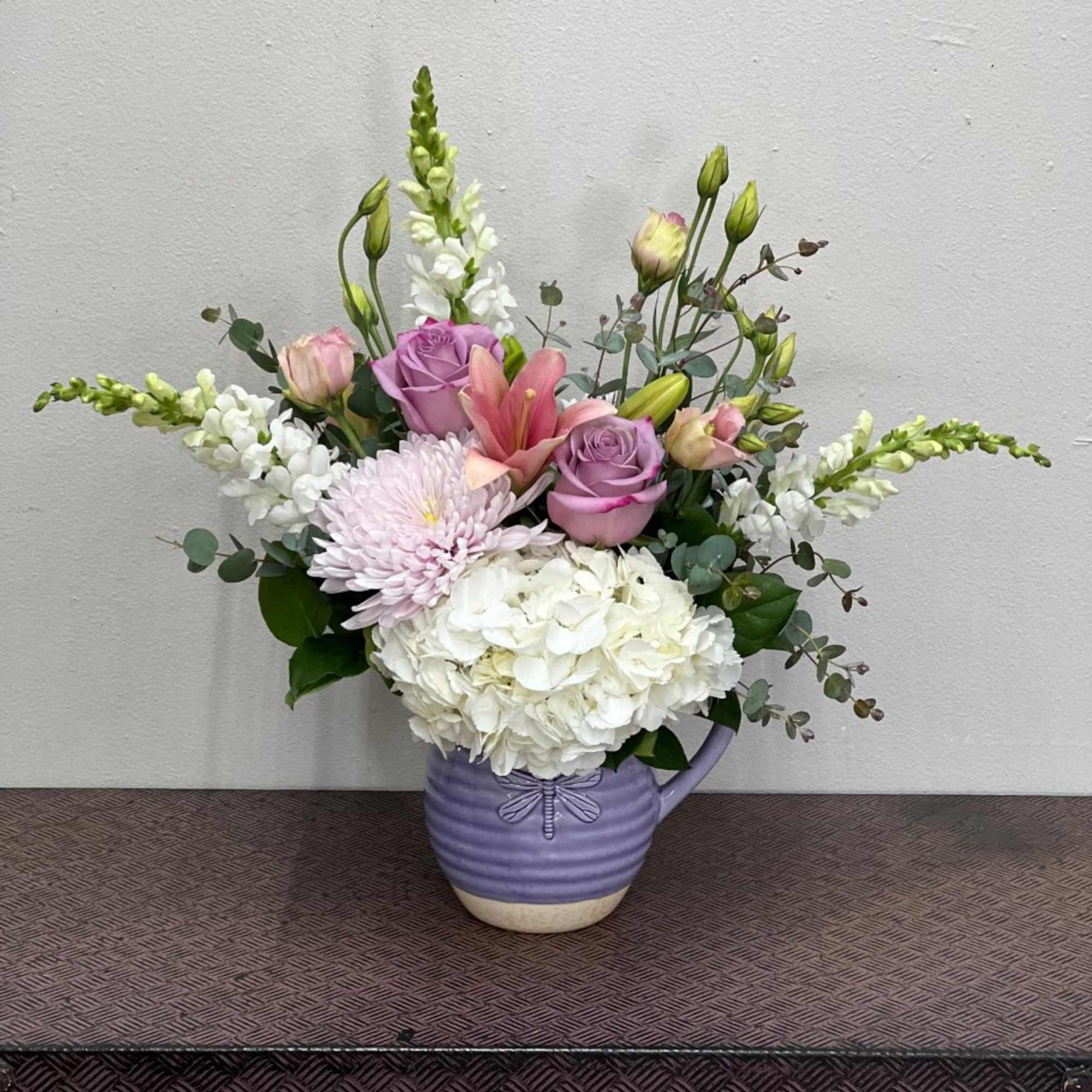 Mixed bouquet in a lavender ceramic pitcher