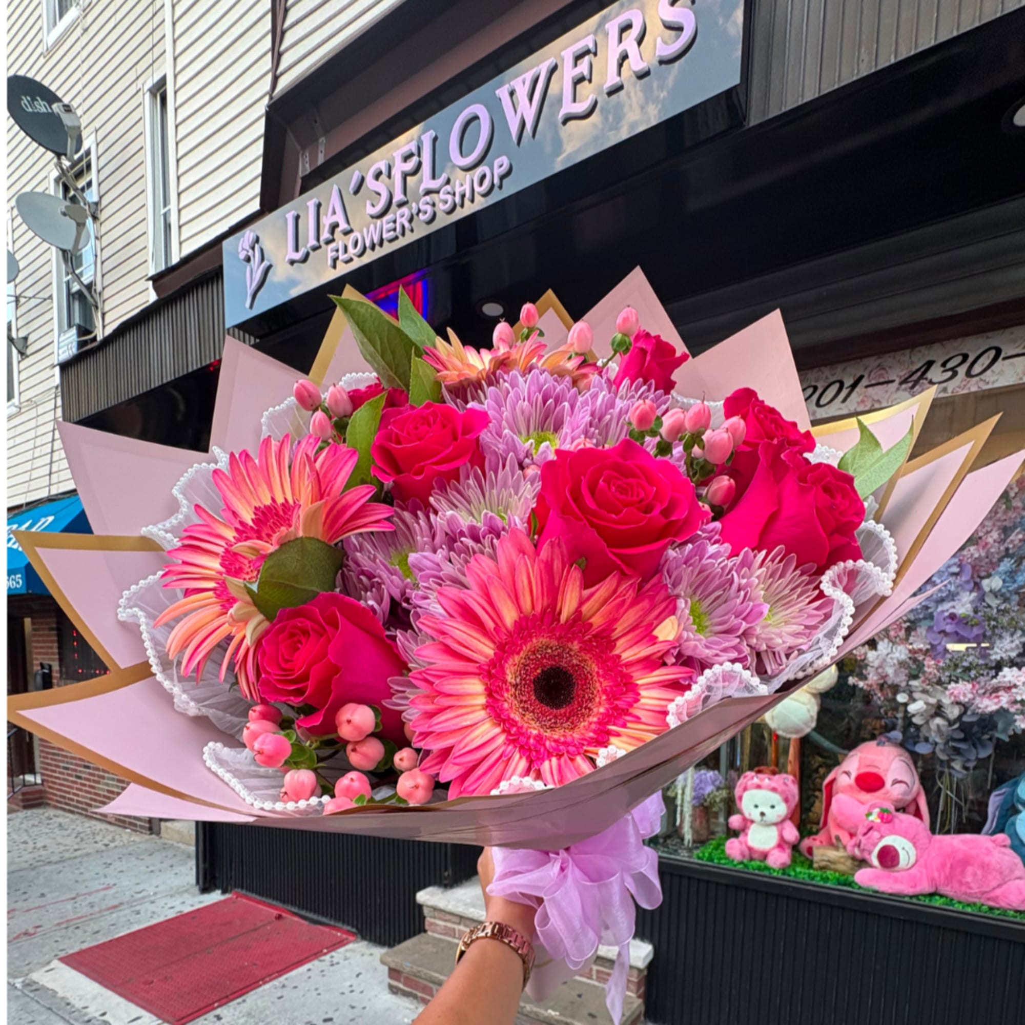 Pink mixed bouquet with roses and gerbera daisies wrapped in pastel paper
