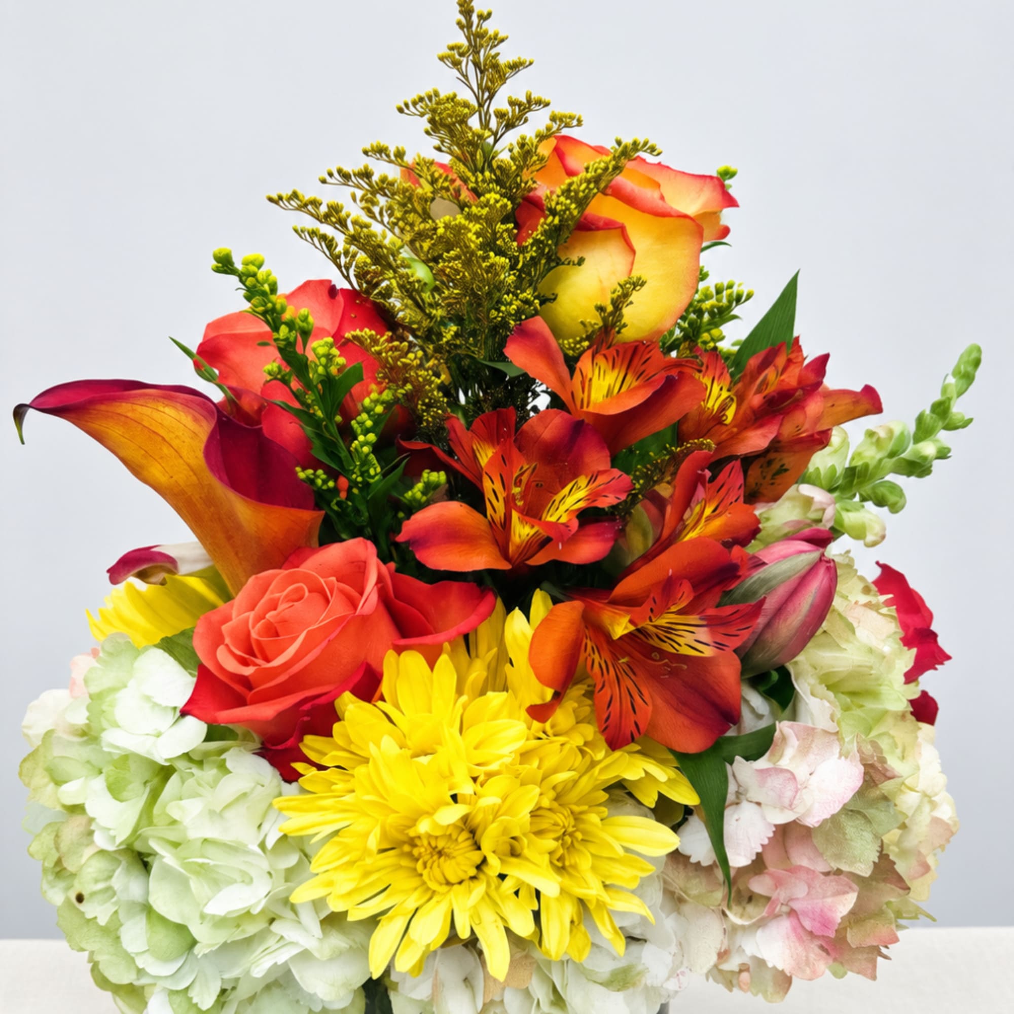Bright mixed bouquet with roses, lilies, hydrangeas, and yellow daisies