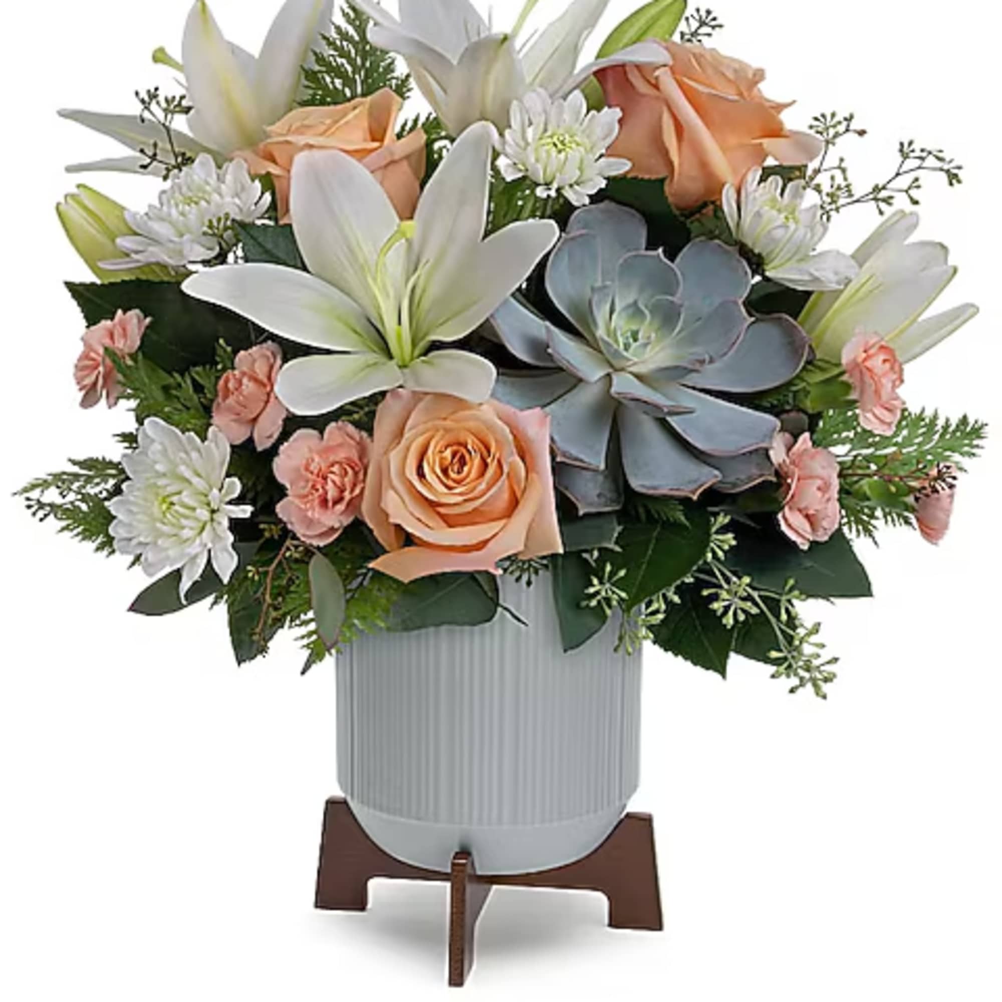 Peach roses, white lilies, and white daisies in a ribbed vase