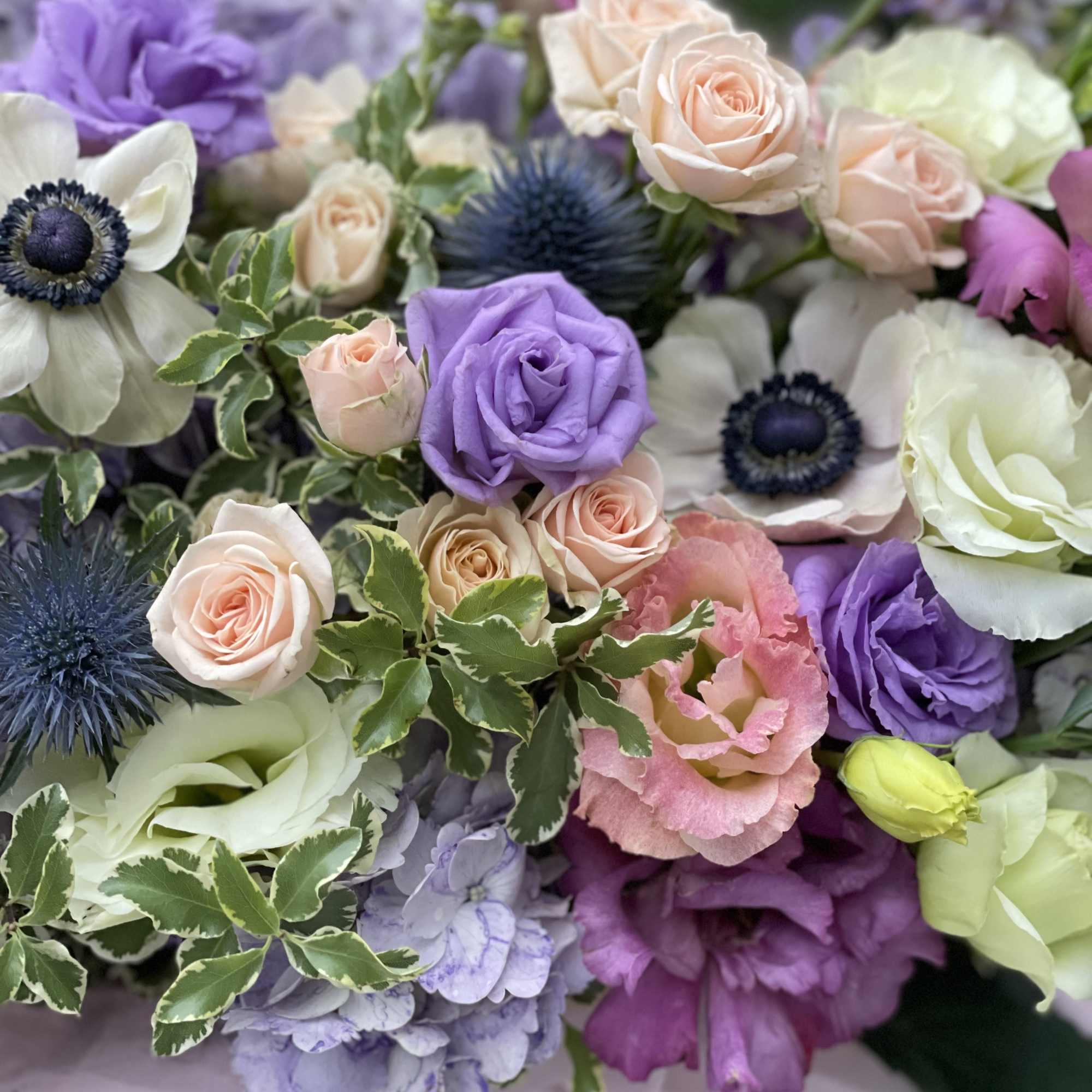 Bouquet of pastel roses, lisianthus, and anemones