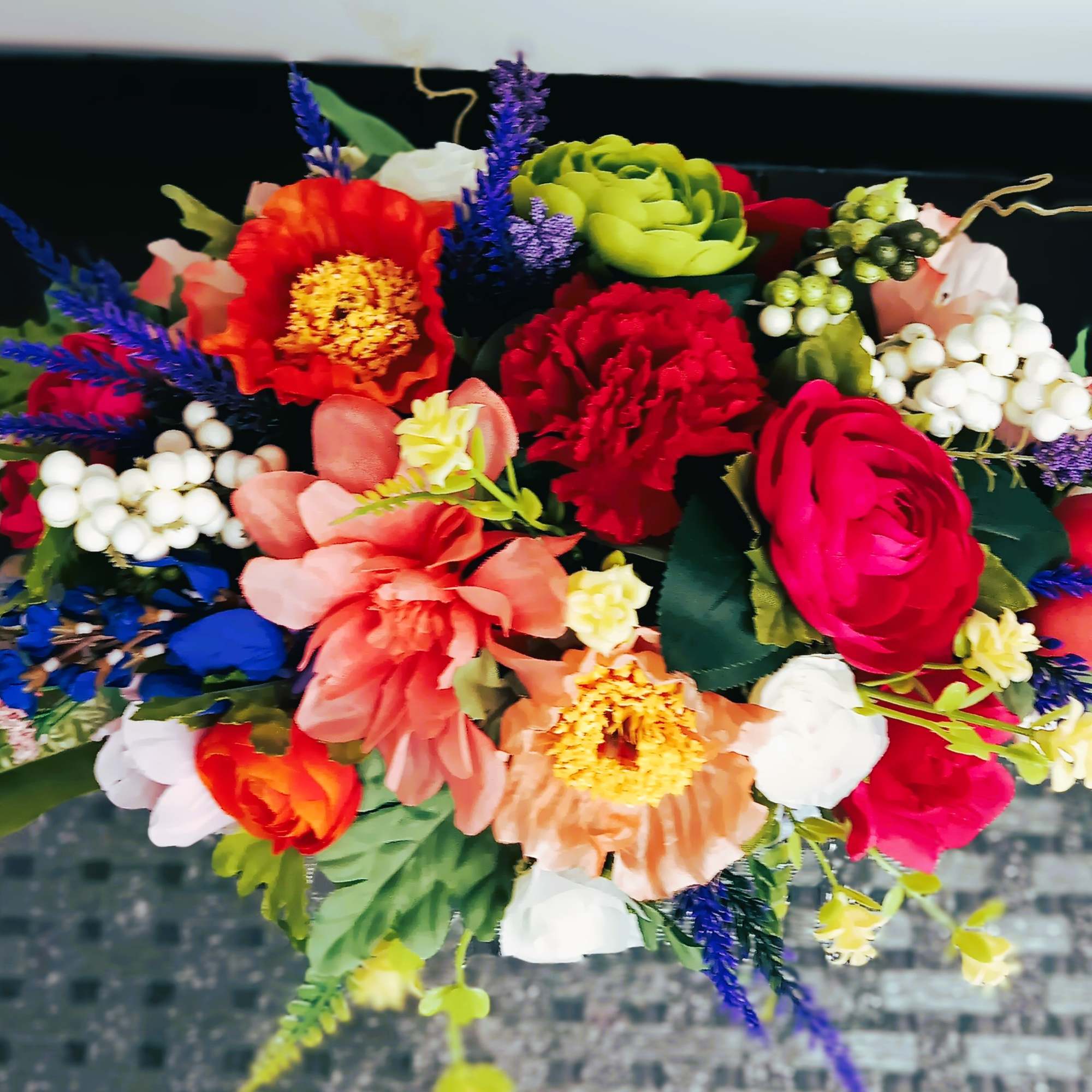 Colorful mixed bouquet with roses, carnations, and berries