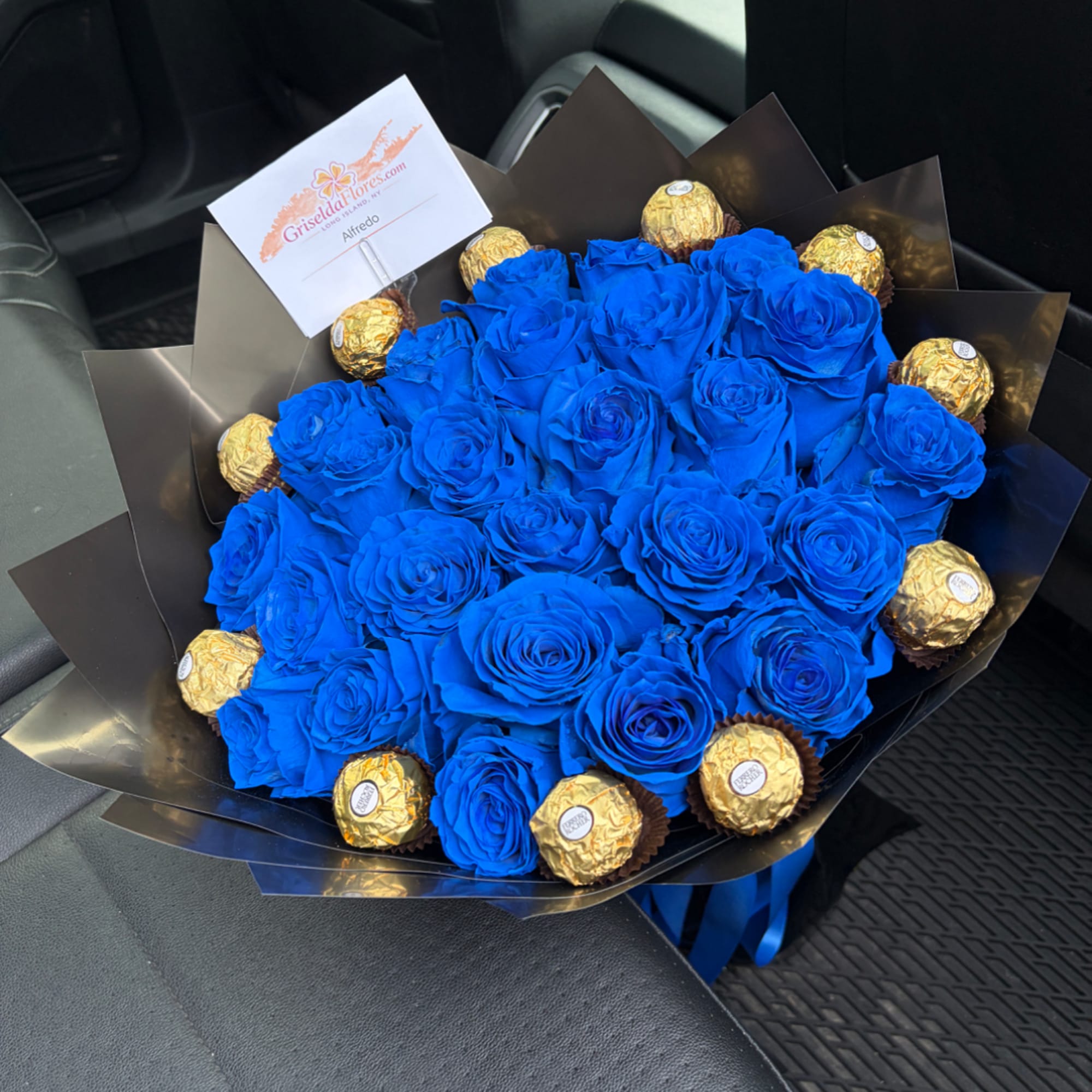 Blue rose bouquet with gold-wrapped chocolates and a card