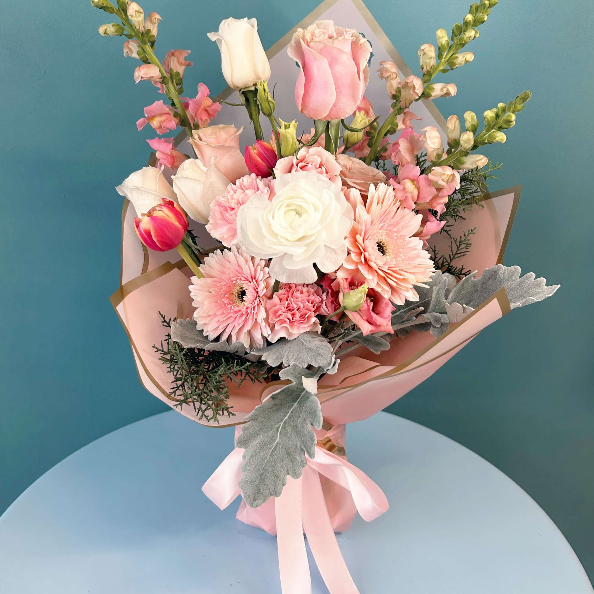 Pink and white mixed bouquet with roses, gerbera daisies, and tulips
