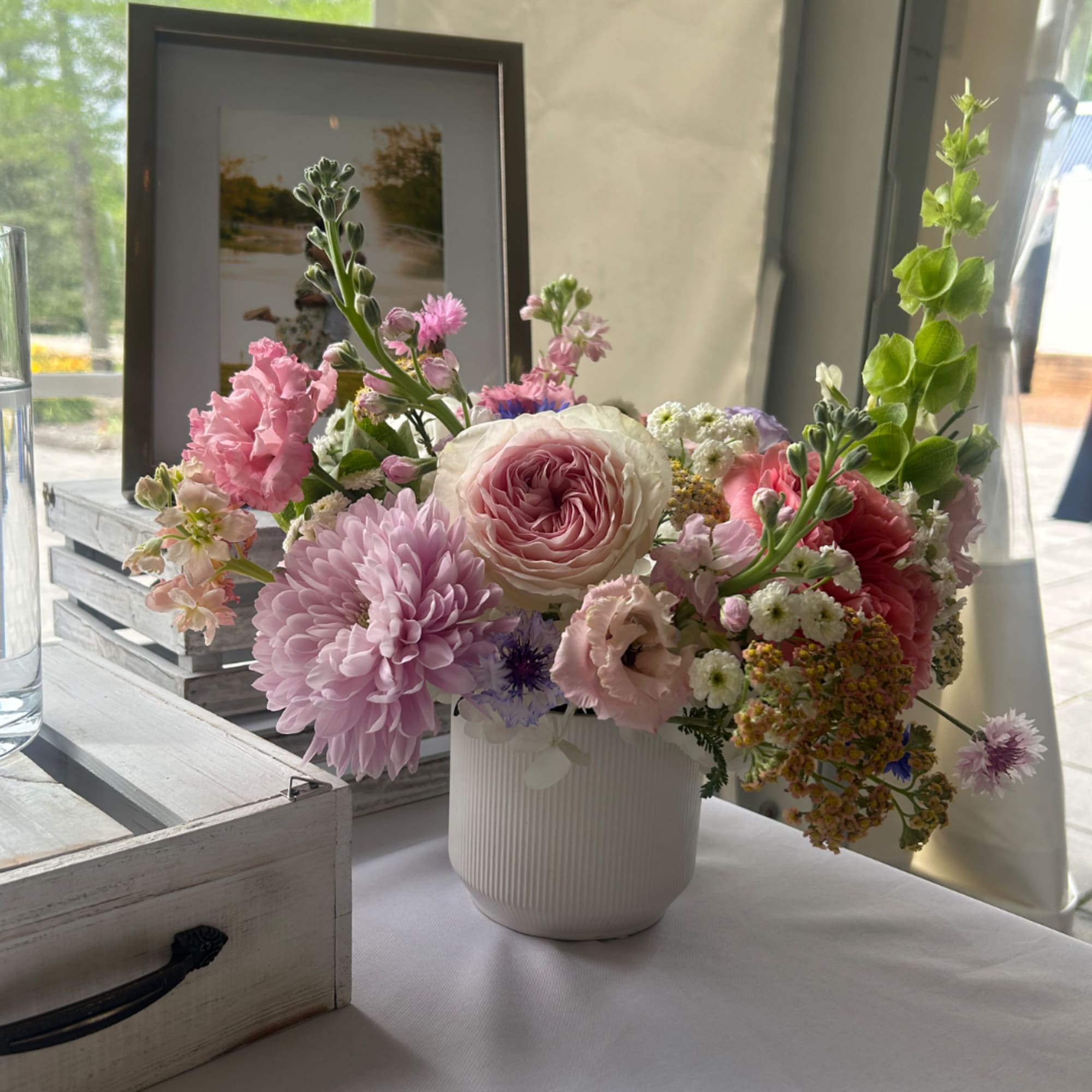 Pink and white mixed flower arrangement in a white vase
