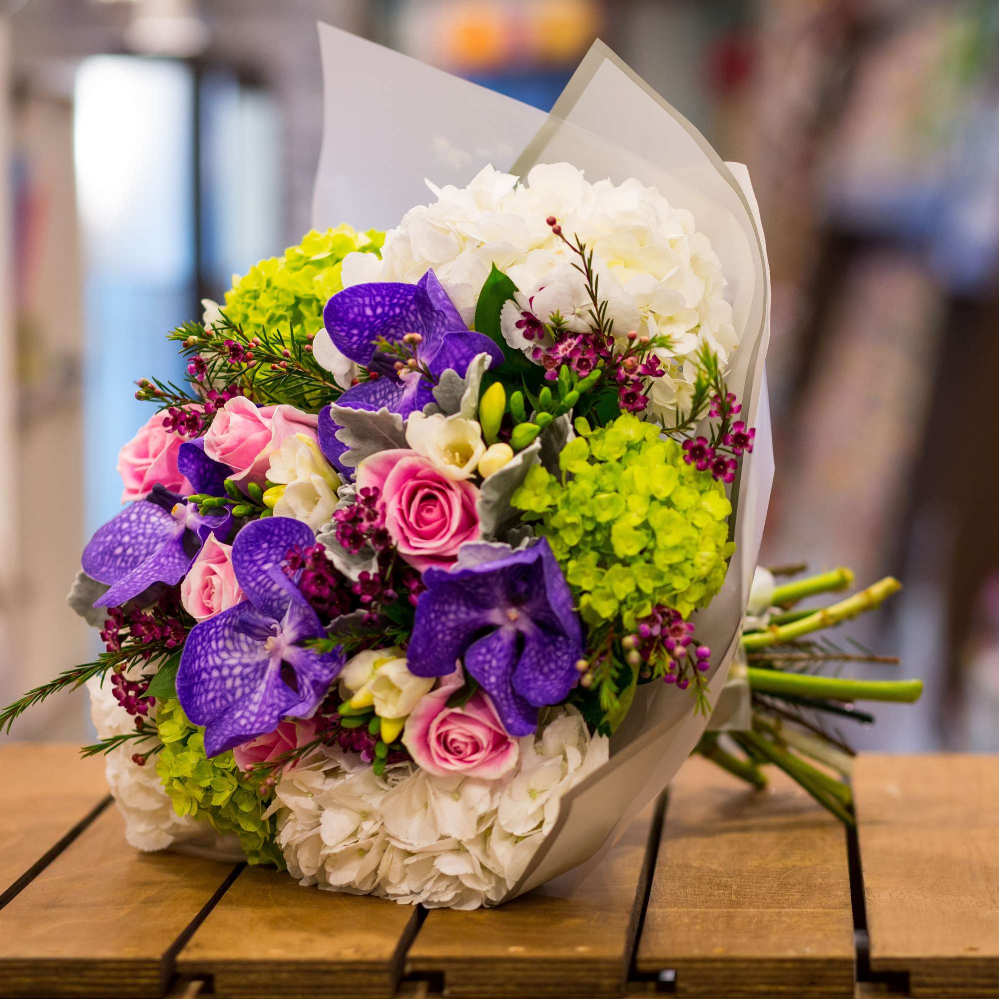 Bouquet of pink roses, white hydrangeas, and purple orchids