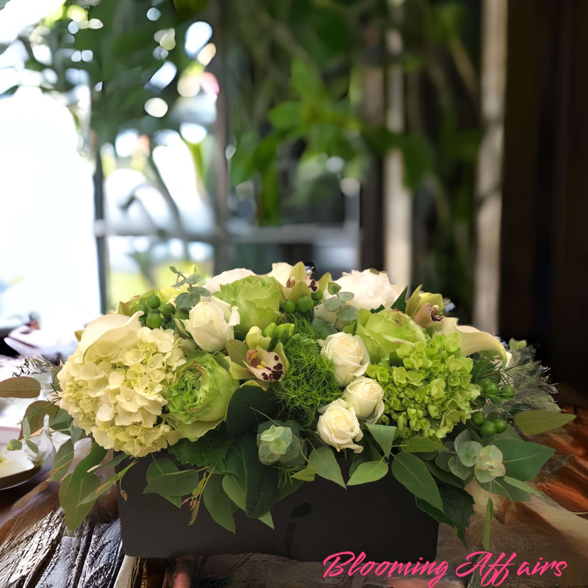 Green and white floral arrangement in a black rectangular box, photo 2 of 3
