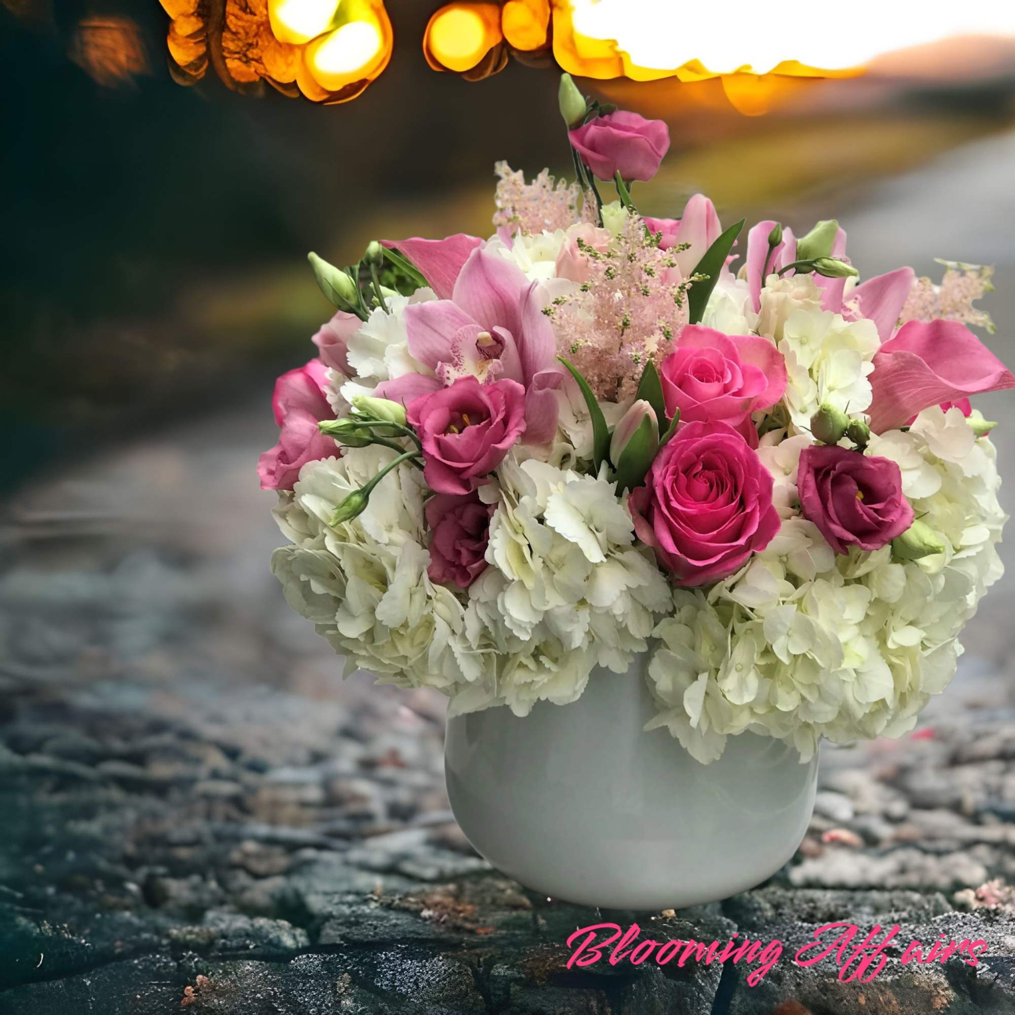 Pink and white floral arrangement in a white vase