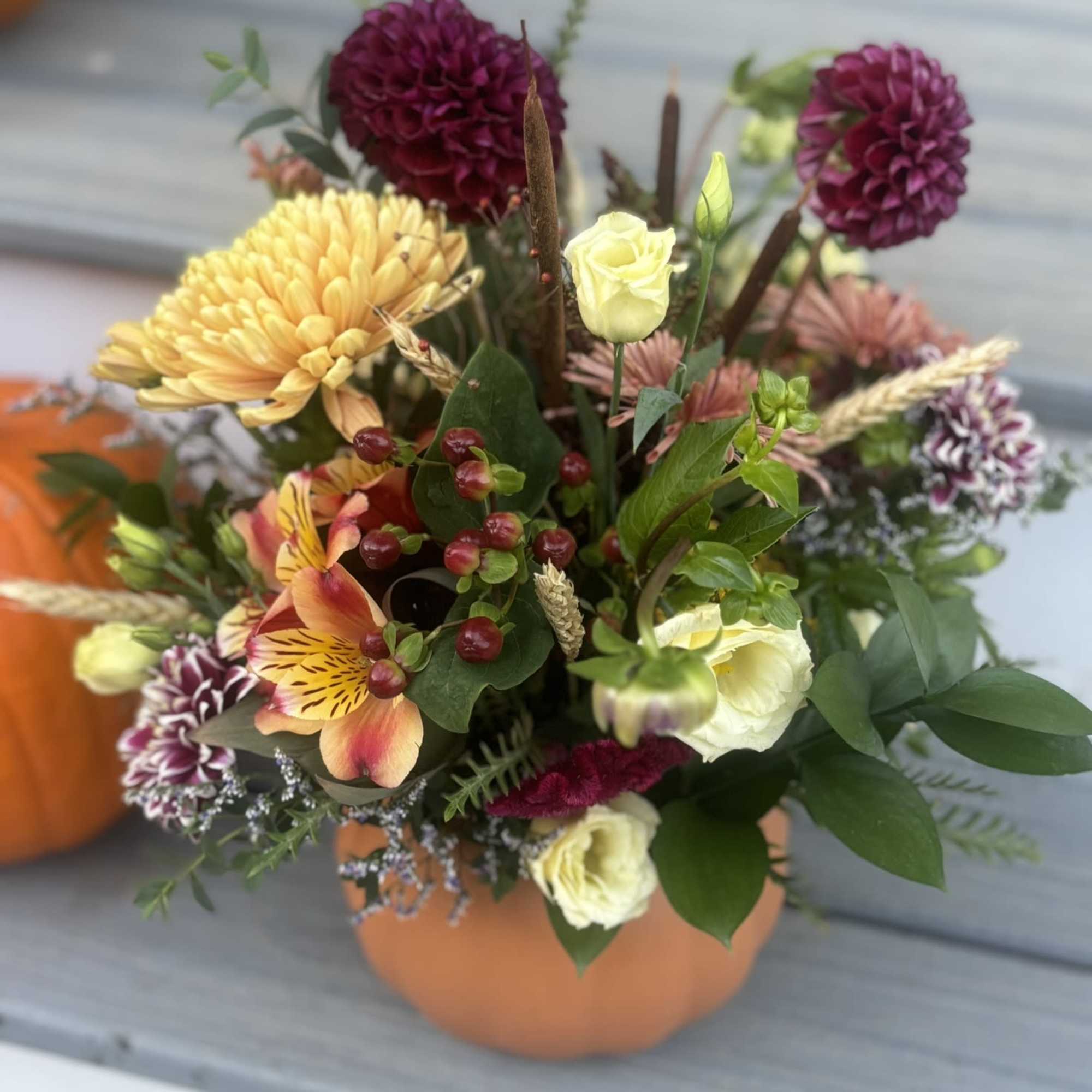Celebrate the season with a handcrafted fall arrangement designed in an 8"