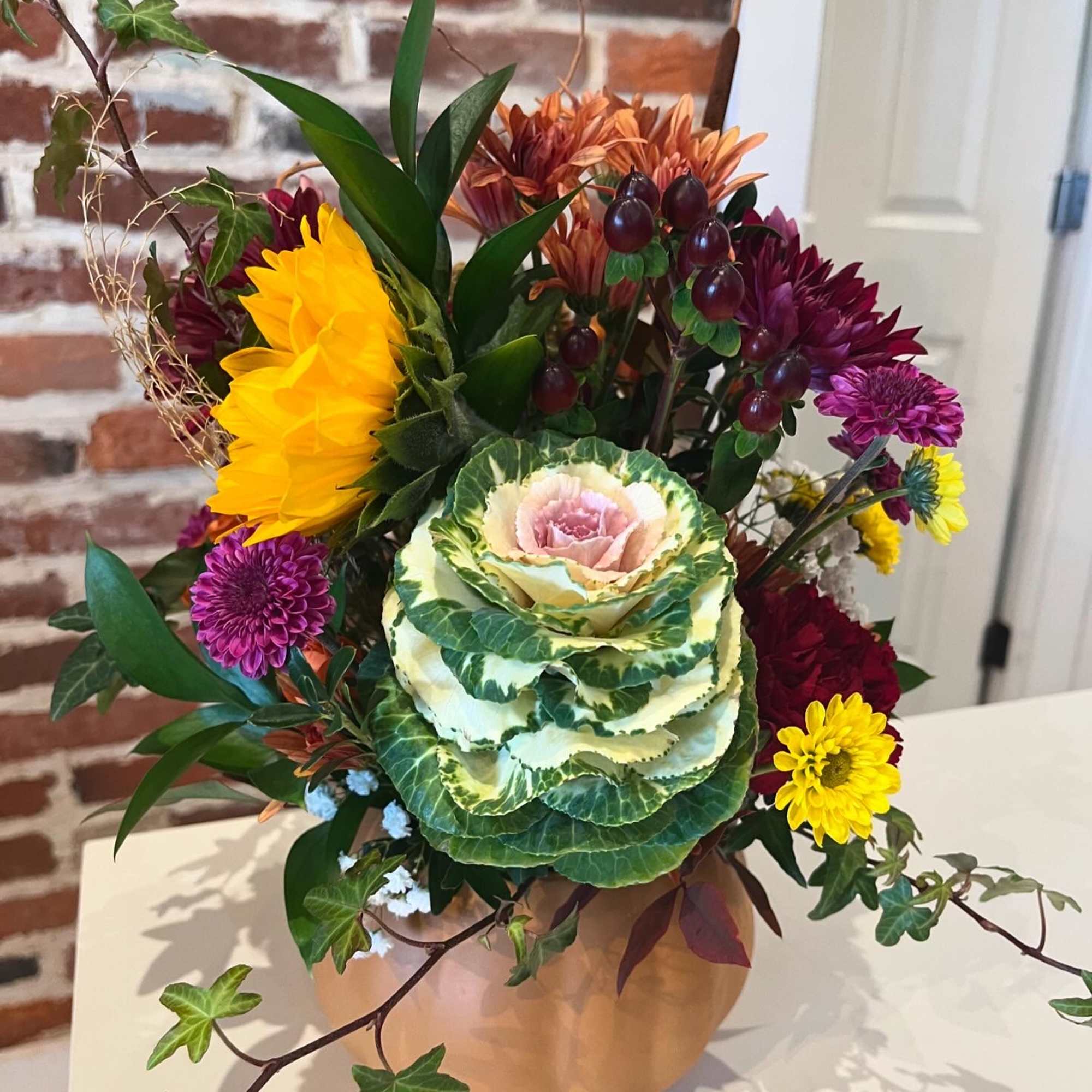 Celebrate the season with a handcrafted fall arrangement designed in an 8"