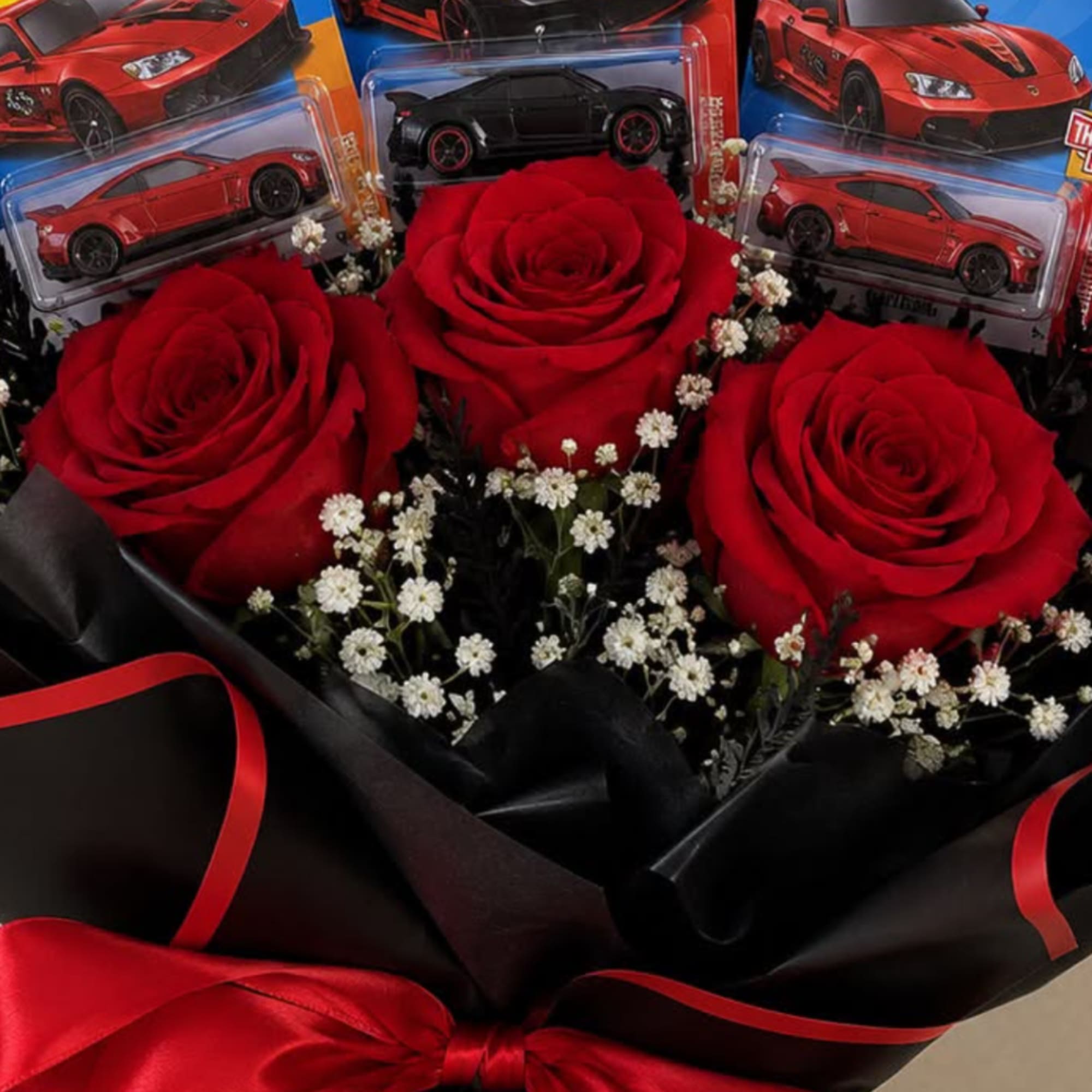 Bouquet of red roses with small white filler flowers and toy cars, photo 2 of 3