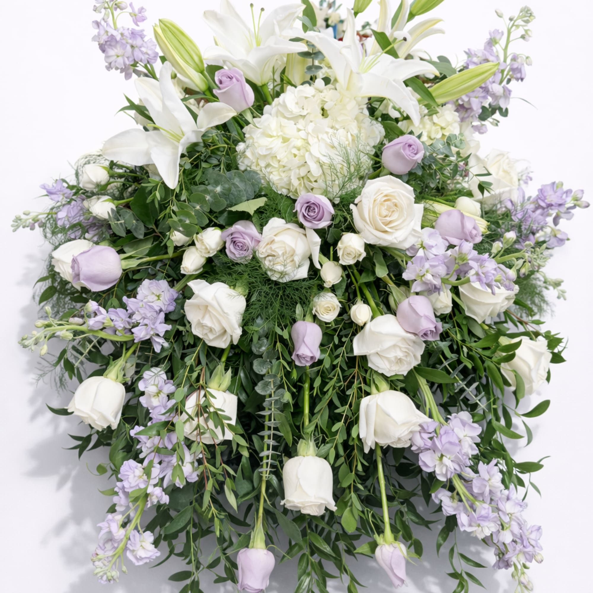 A large, cascading wedding centerpiece that reads as serene and formal, made