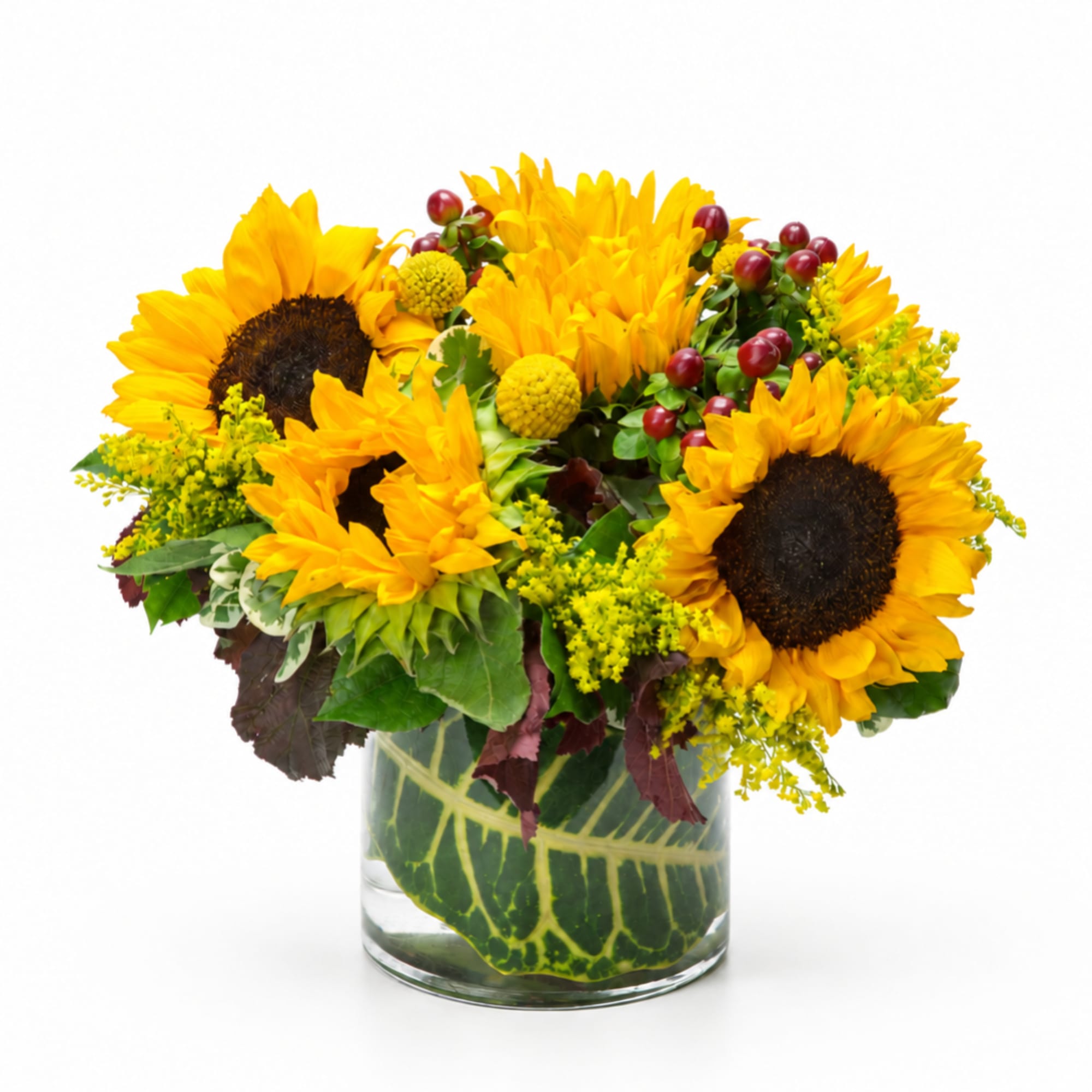 Sunflower bouquet in a clear glass vase with yellow filler flowers