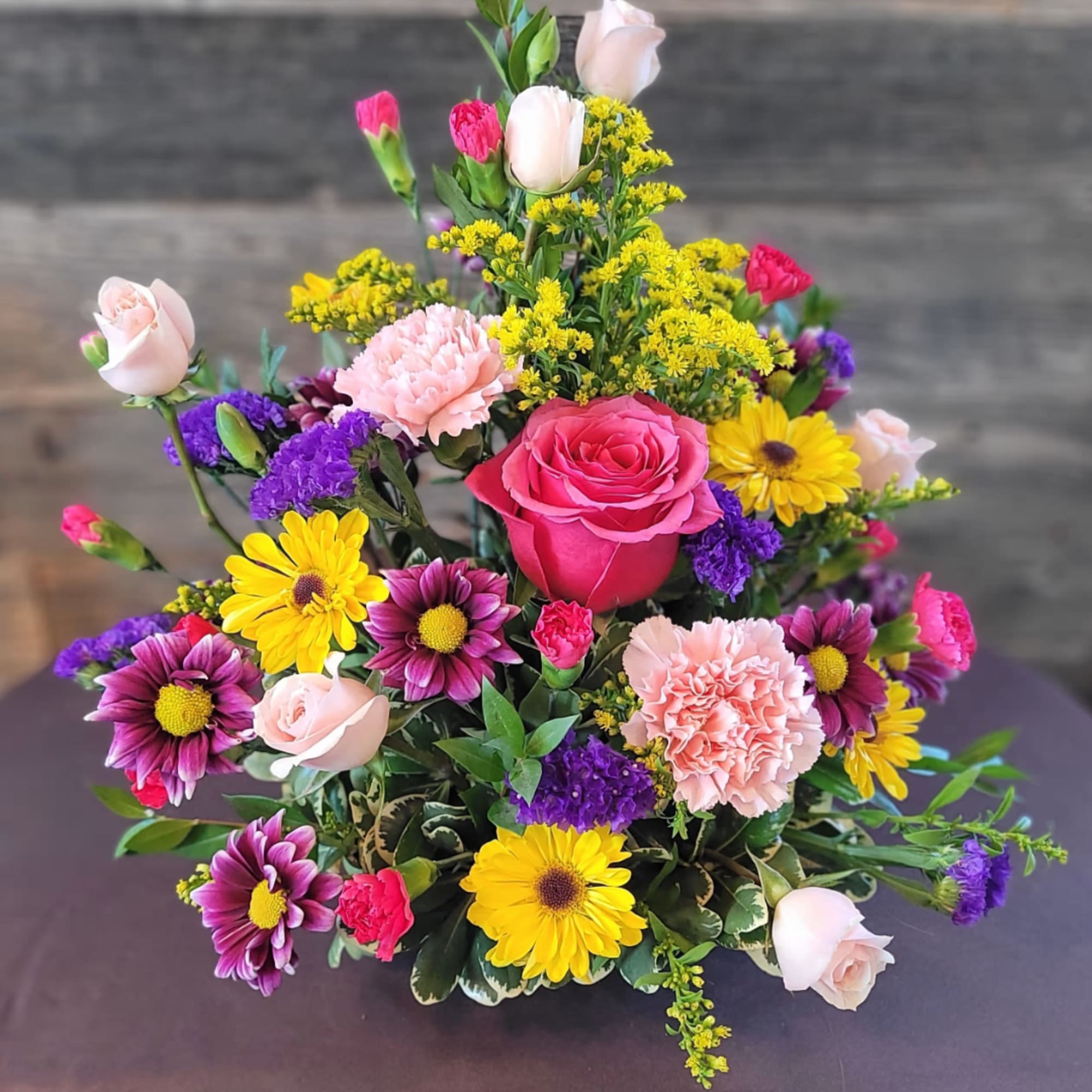 Mixed bouquet with pink roses, carnations, and yellow daisies