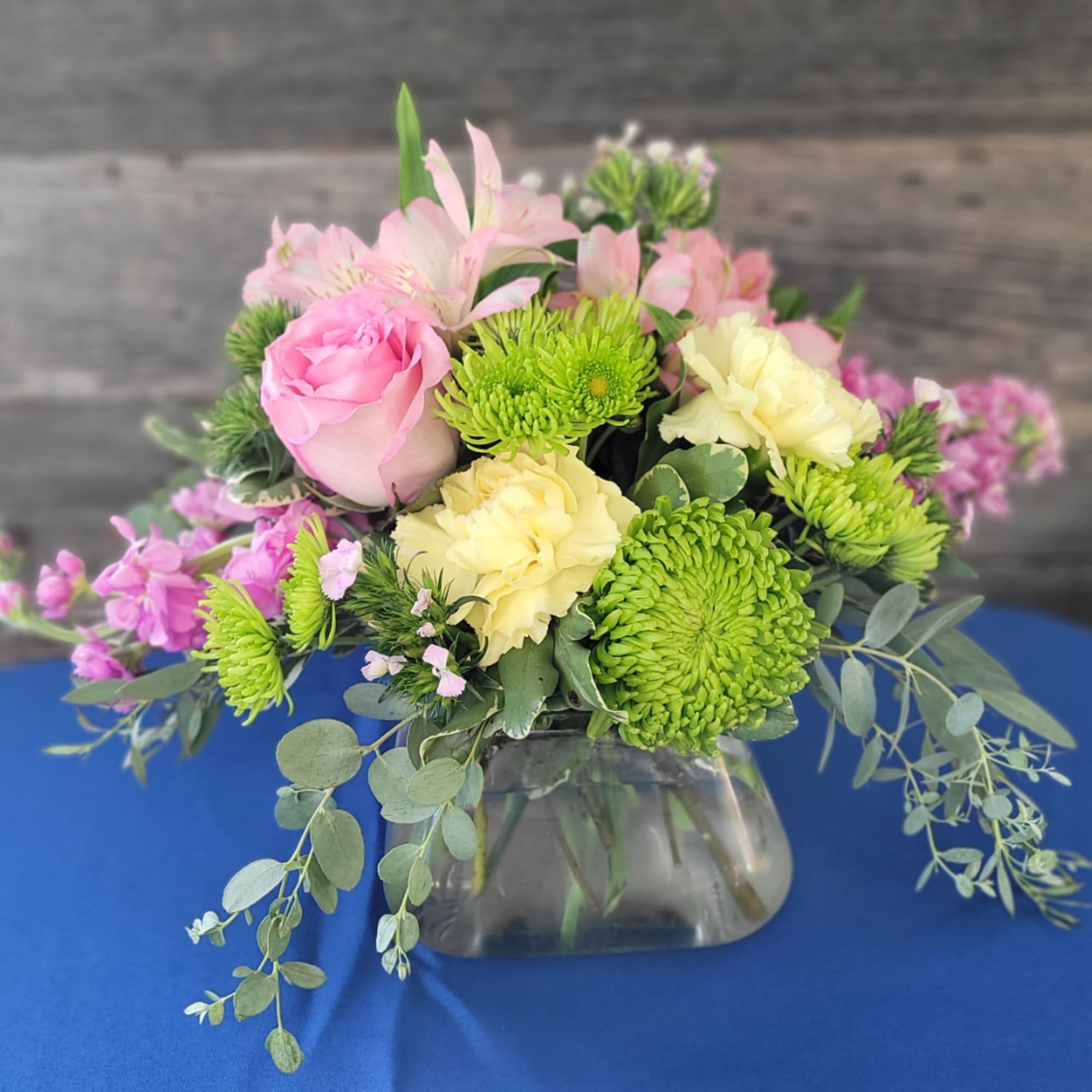 Pink and yellow mixed bouquet in a glass vase