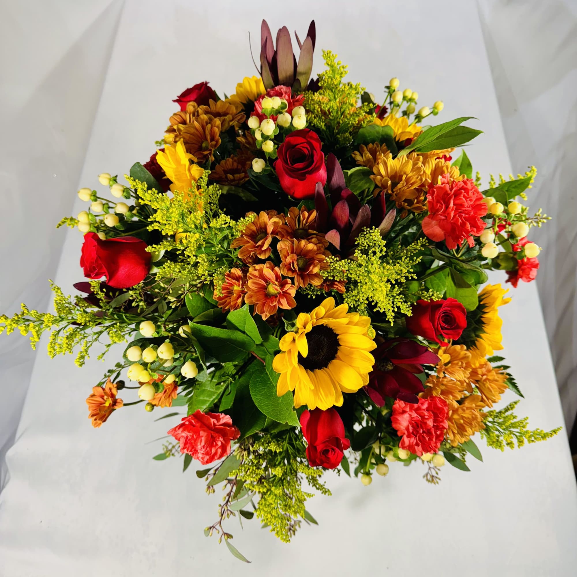 Mixed bouquet with red roses, sunflowers, and orange mums