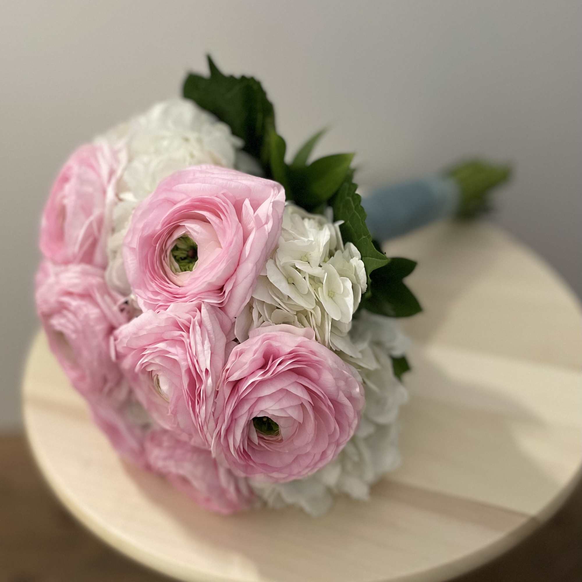 Bouquet of pink and white flowers with green leaves