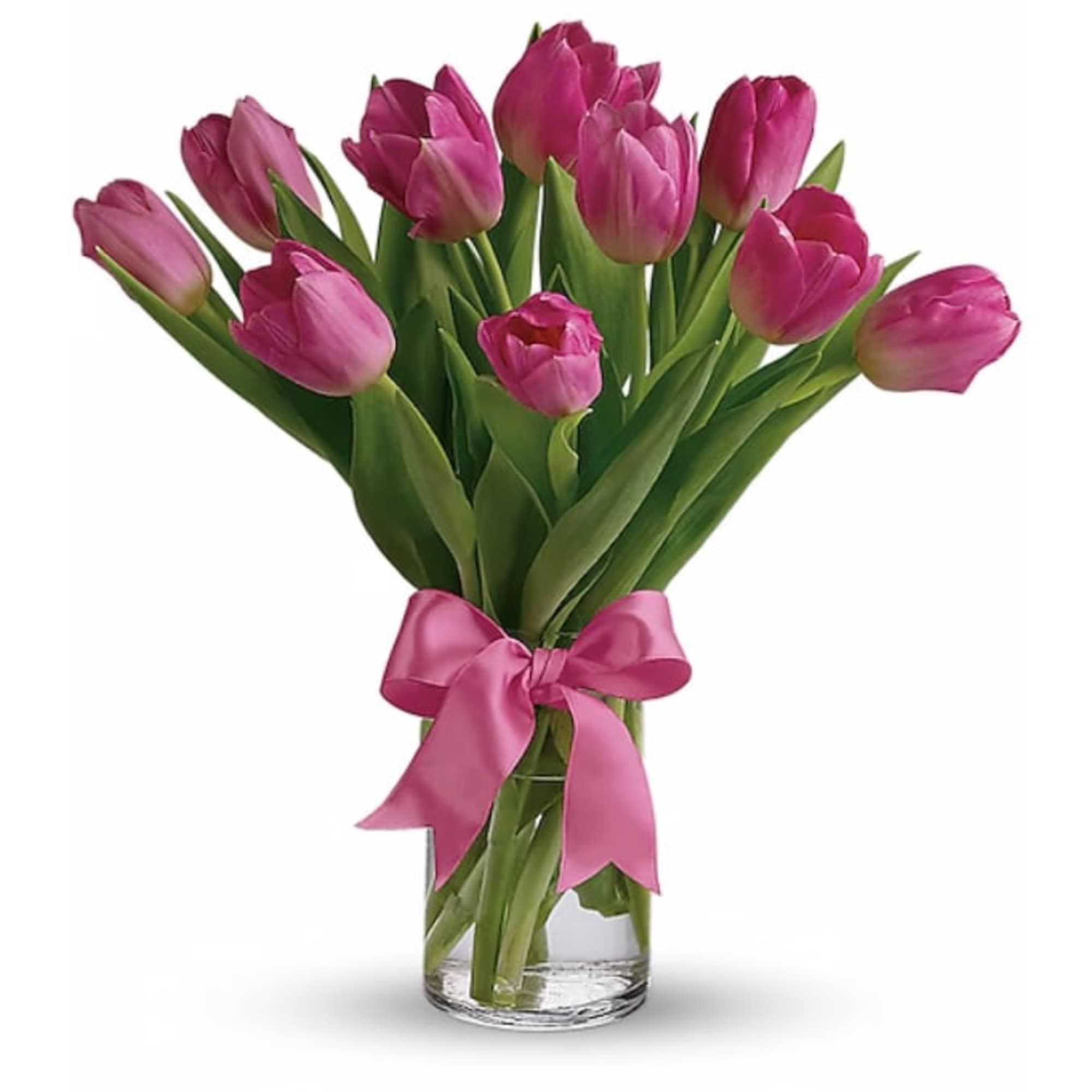 Arrangement of bright pink tulips in a clear glass vase tied with a pink ribbon.
