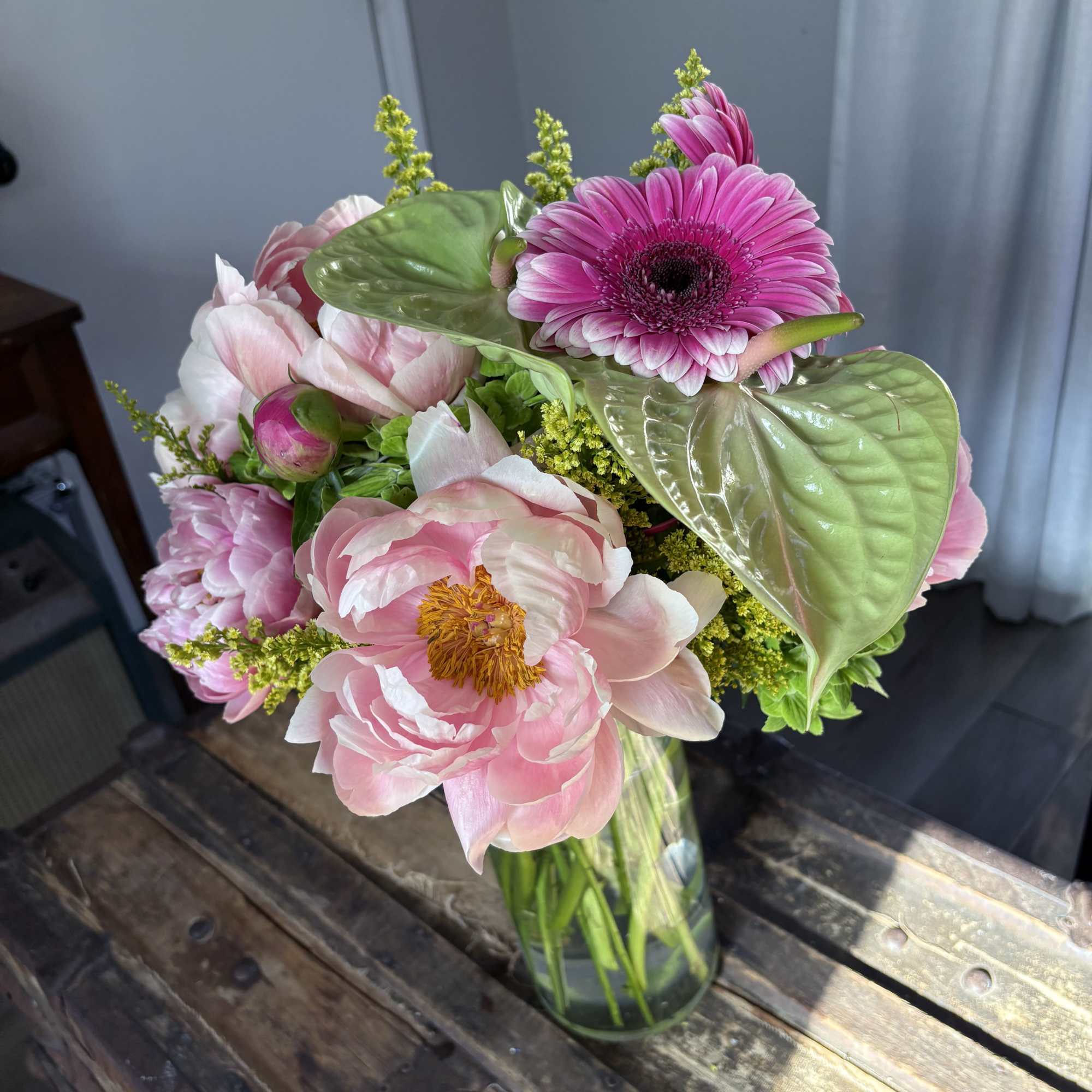 Pink and white bouquet in a glass vase with a bright pink gerbera daisy