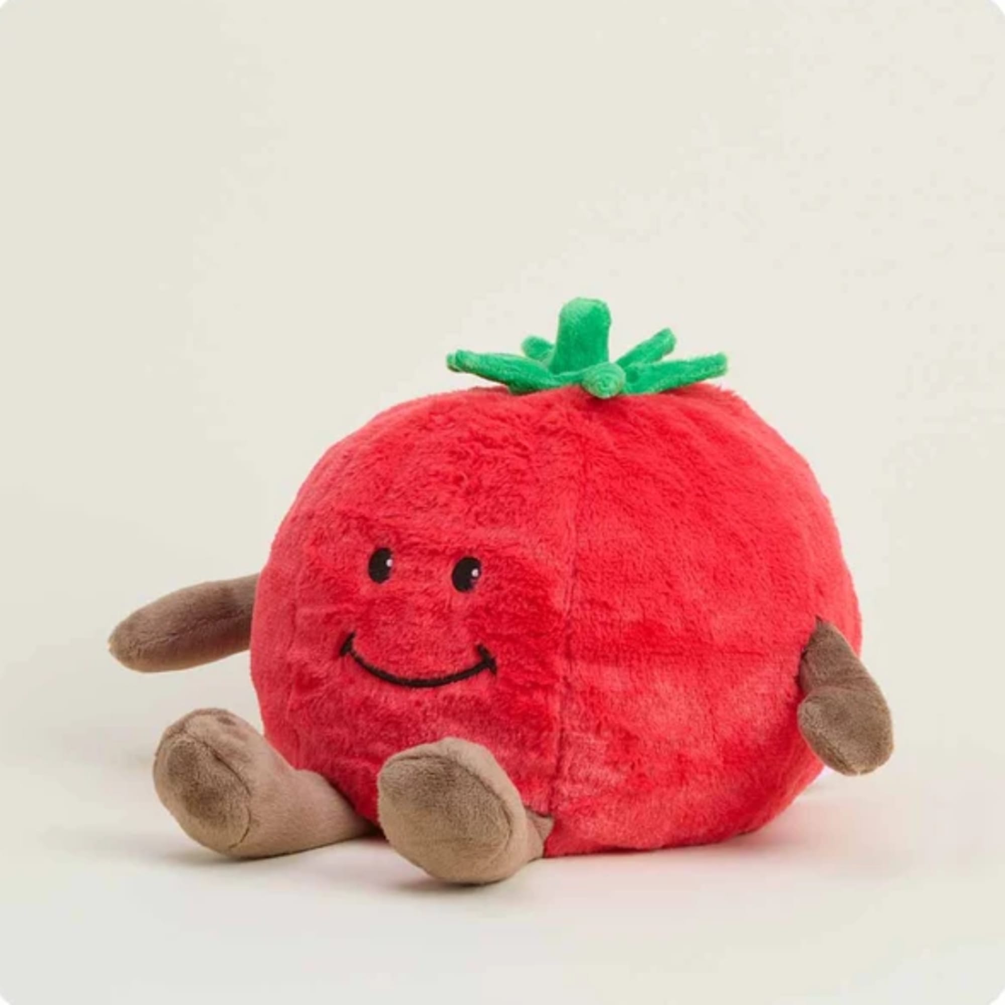 Plush tomato-shaped stuffed toy with a smiling face and small limbs
