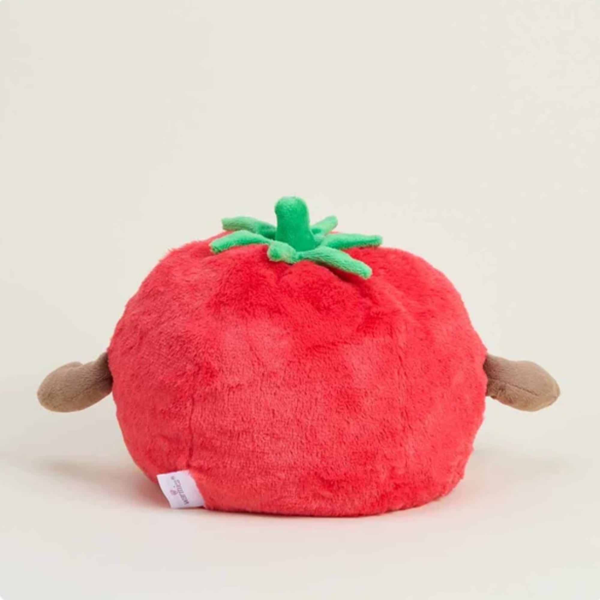 Plush tomato-shaped toy with green top and small side arms