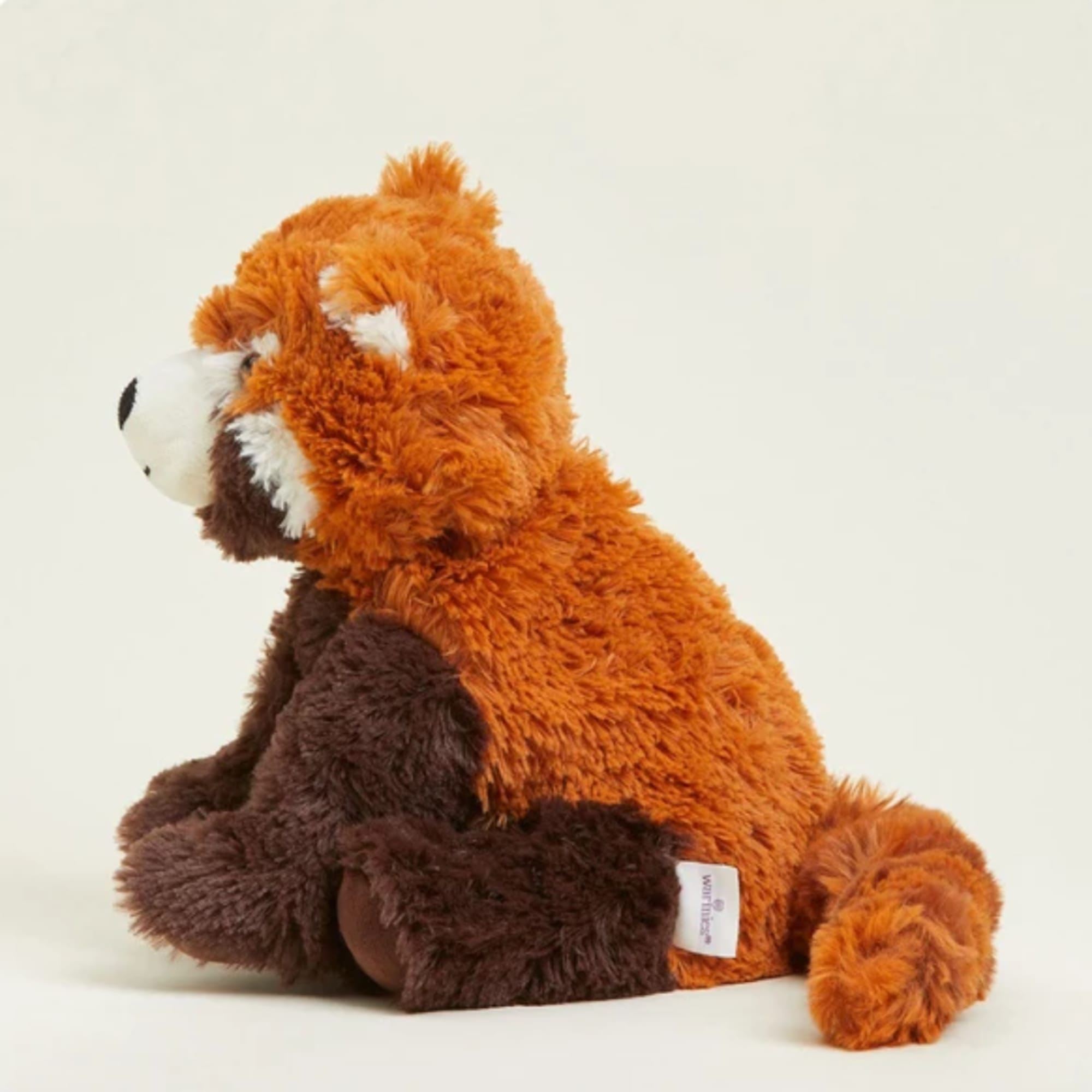 Plush red panda stuffed animal sitting on a plain background