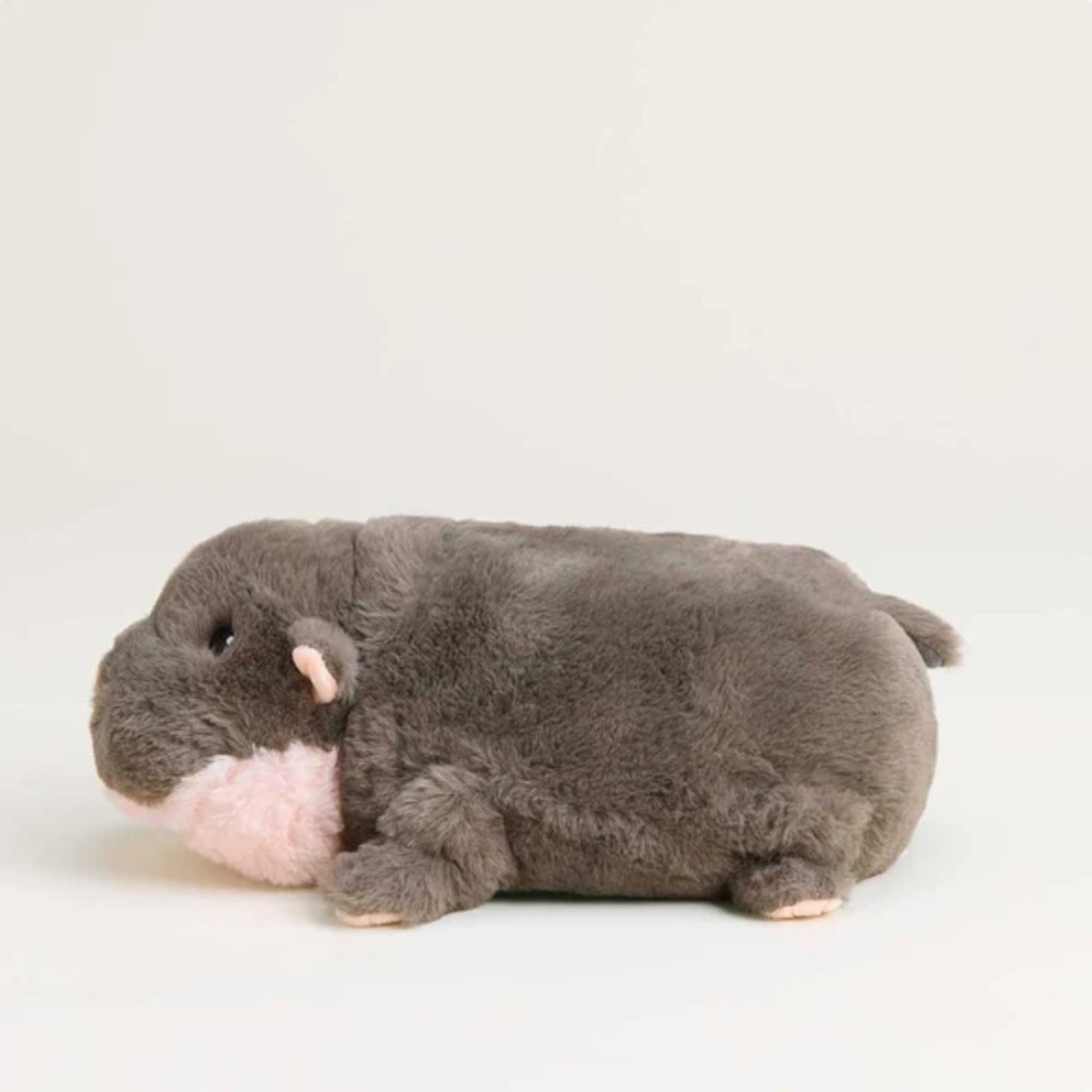Gray plush hippo toy with a pink snout on a plain white background