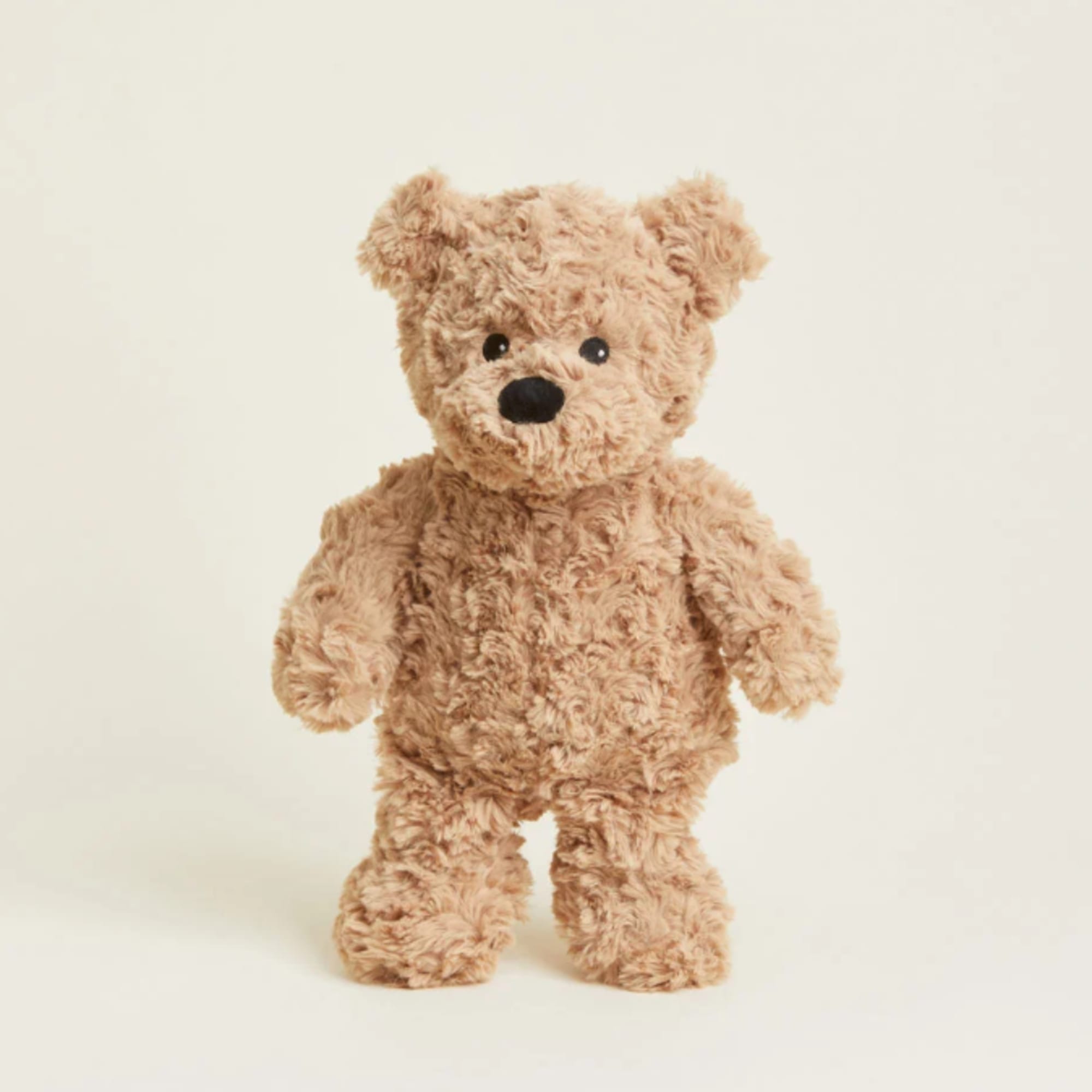 Small tan teddy bear plush standing on a plain background